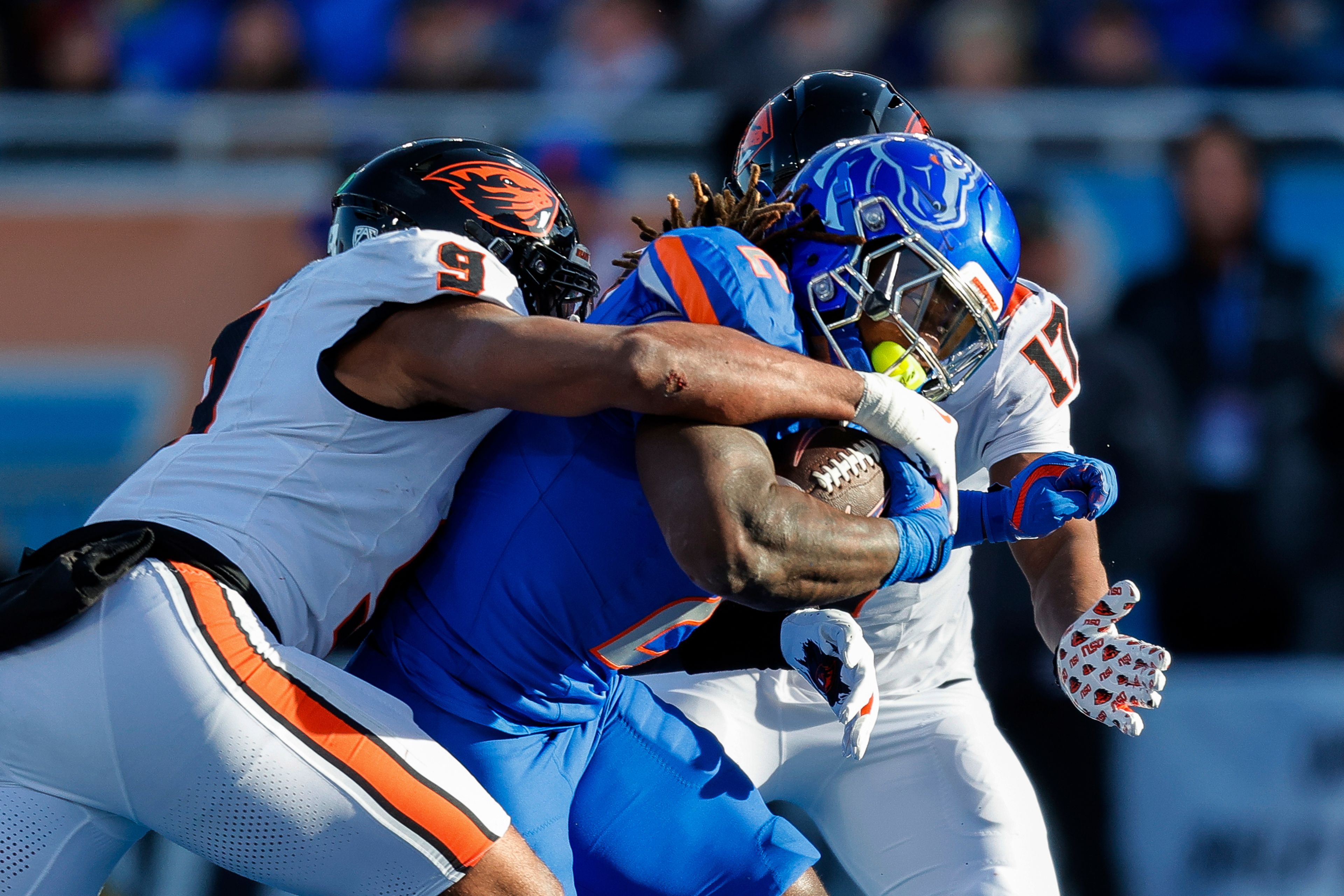 Boise State running back Ashton Jeanty (2) battles on a 7 yard touchdown run against the tackle attempt by Oregon State linebacker Isaiah Chisom (9) and defensive back Jaydin Young (19) in the first half of an NCAA college football game, Friday, Nov. 29, 2024, in Boise, Idaho. (AP Photo/Steve Conner)