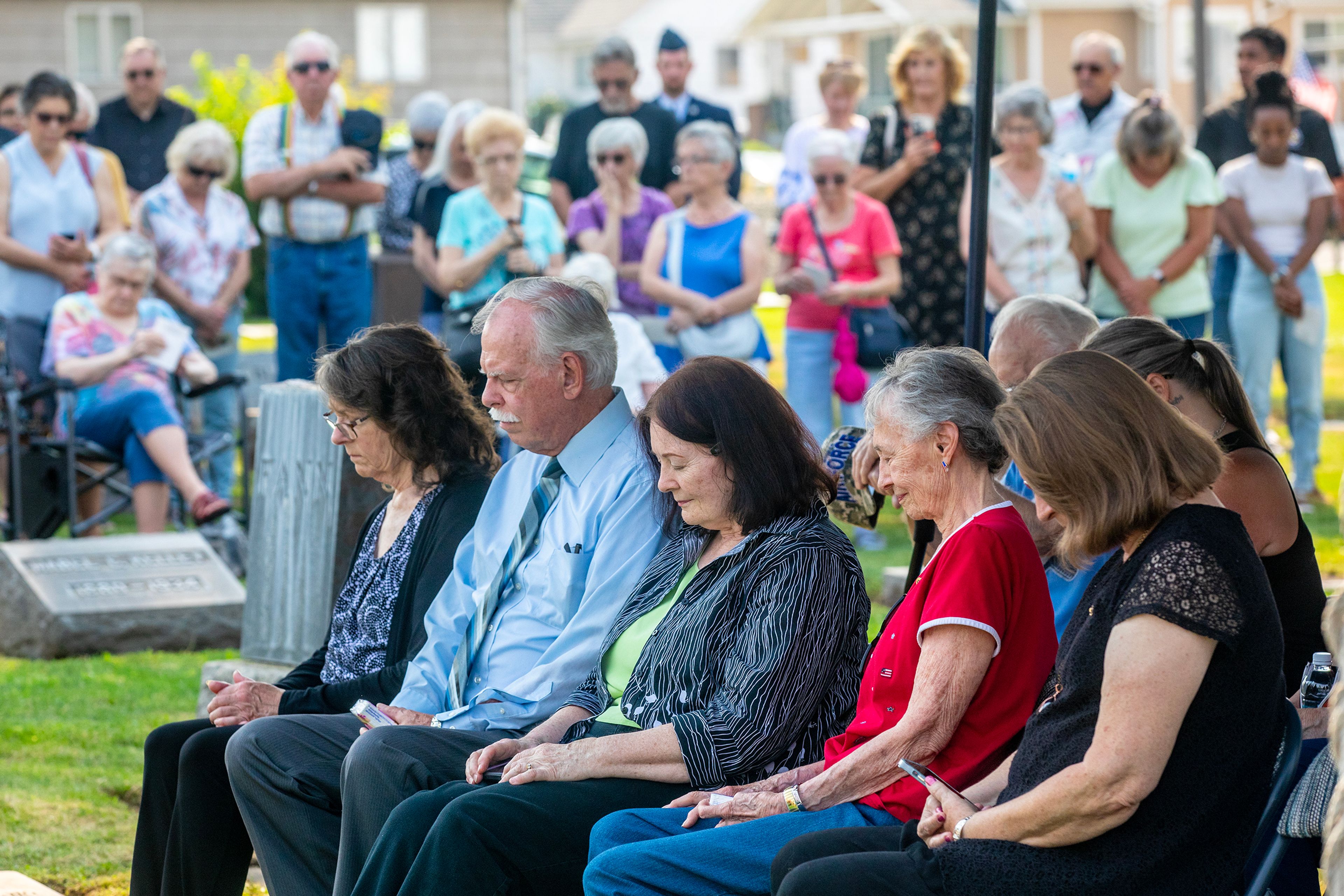 The family of Allan Knepper bows their heads for a prayer at his funeral Thursday at the Normal Hill Cemetery in Lewiston.