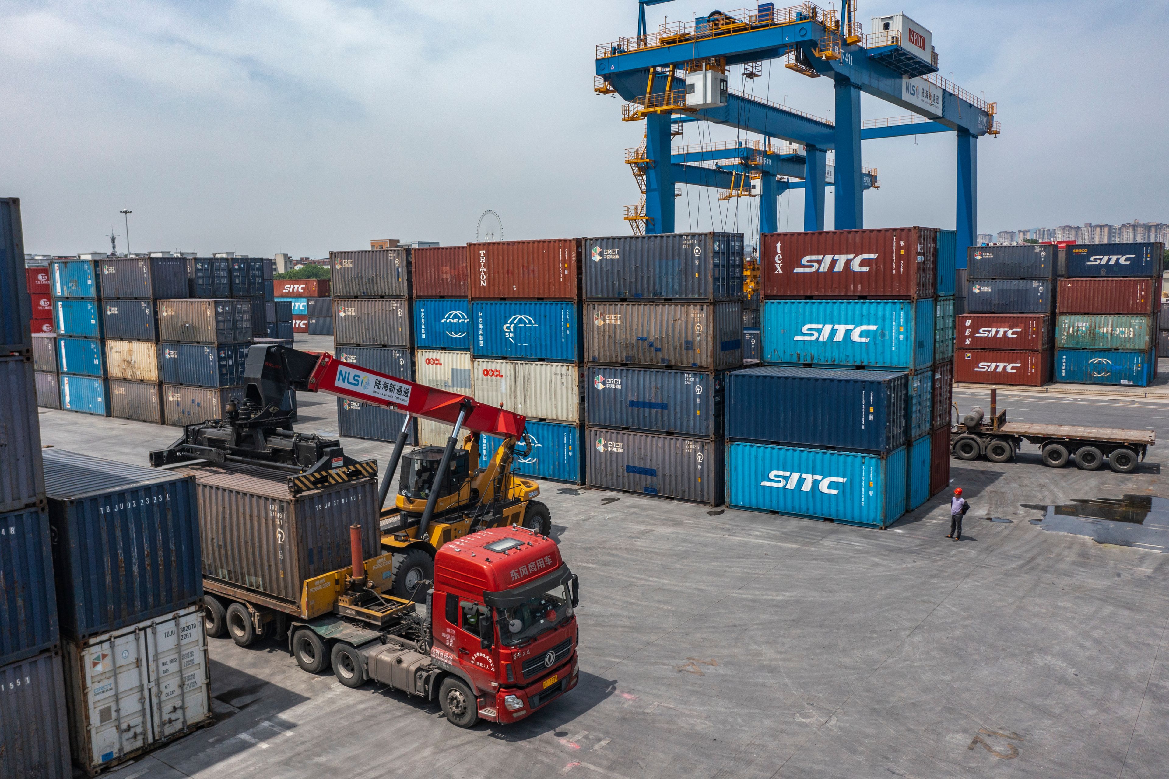 FILE - In this photo released by Xinhua News Agency, a truck transfers a container at the Tuanjiecun Station in the Chongqing International Logistics Hub Park in southwest China's Chongqing Municipality on May 5, 2024. China's exports for May beat analyst expectations despite trade tensions, though imports shrank, according to customs data released Friday, June 7, 2024.