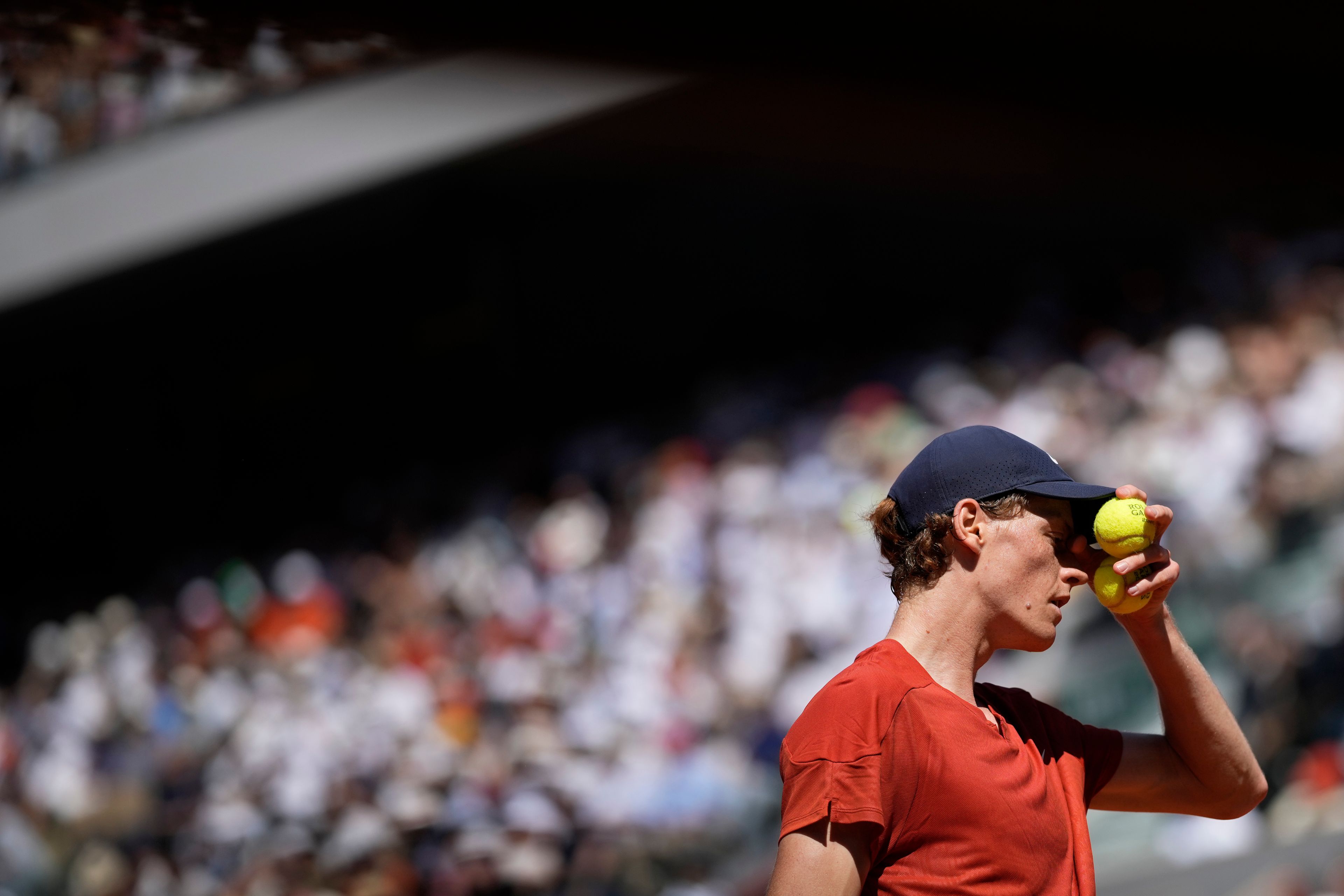 Italy's Jannik Sinner preapres to serve against Spain's Carlos Alcaraz during their semifinal match of the French Open tennis tournament at the Roland Garros stadium in Paris, Friday, June 7, 2024.