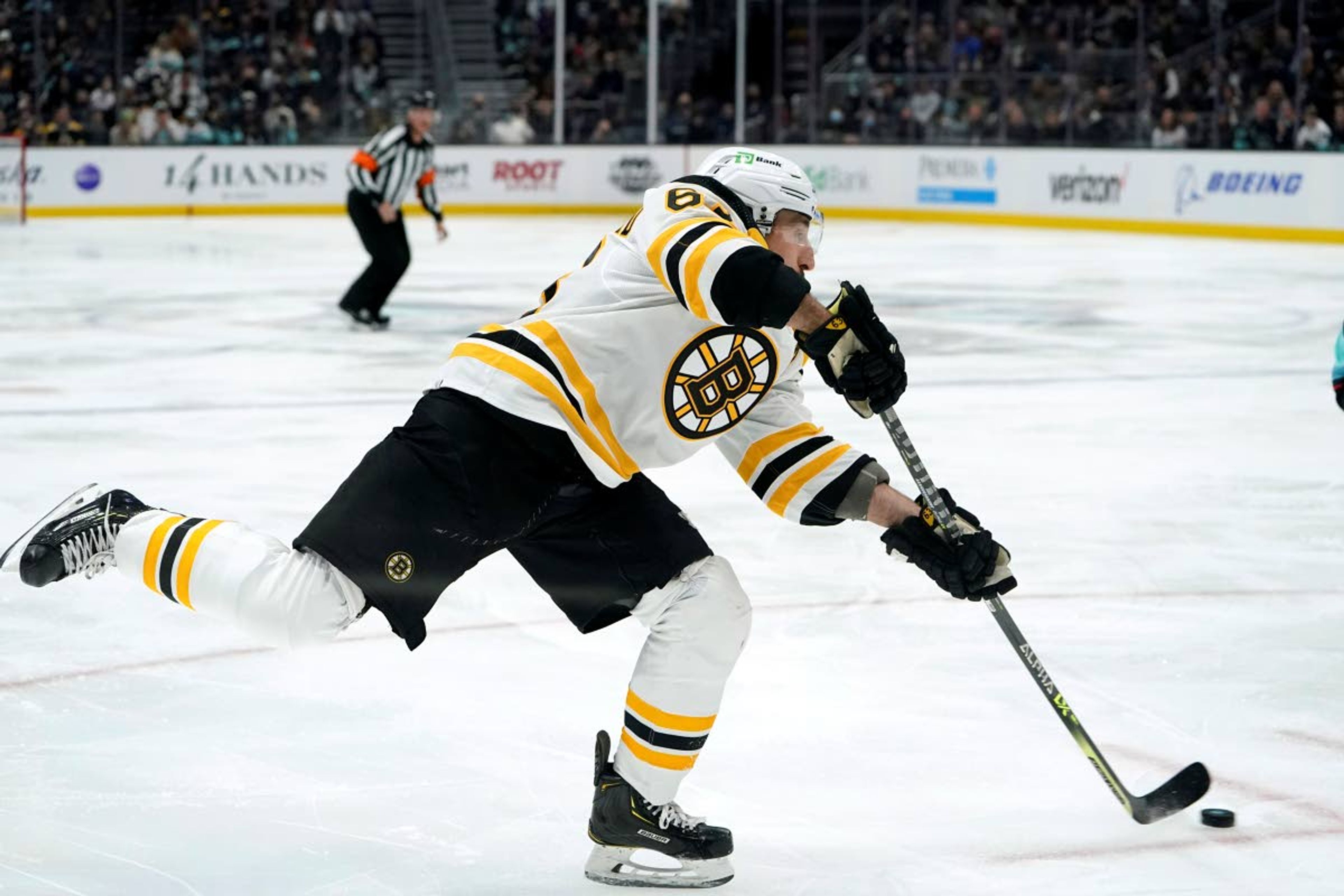 Boston Bruins' Brad Marchand shoots against the Seattle Kraken during the first period of an NHL hockey game Thursday, Feb. 24, 2022, in Seattle. (AP Photo/Elaine Thompson)