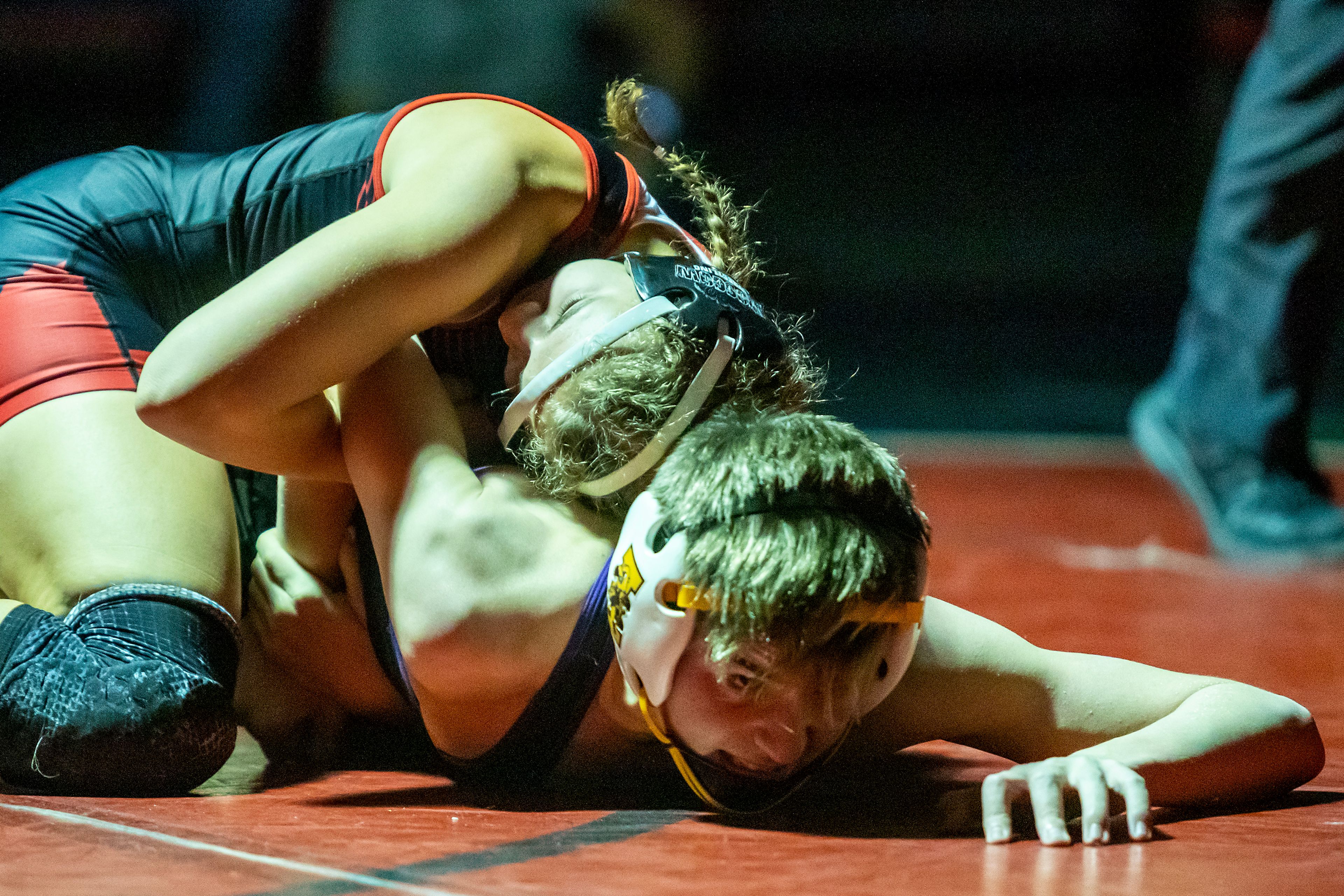 Moscow’s Skyla Zimmerman, top, wrestles Lewiston’s Jase Hendren in Moscow during a Dec. 11, 2021, dual meet. Zimmerman, the 18th-ranked girls wrestler in the nation at 112 pounds, will compete in college for Southern Oregon, the top-ranked team in the NAIA, after accepting a partial scholarship Wednesday.