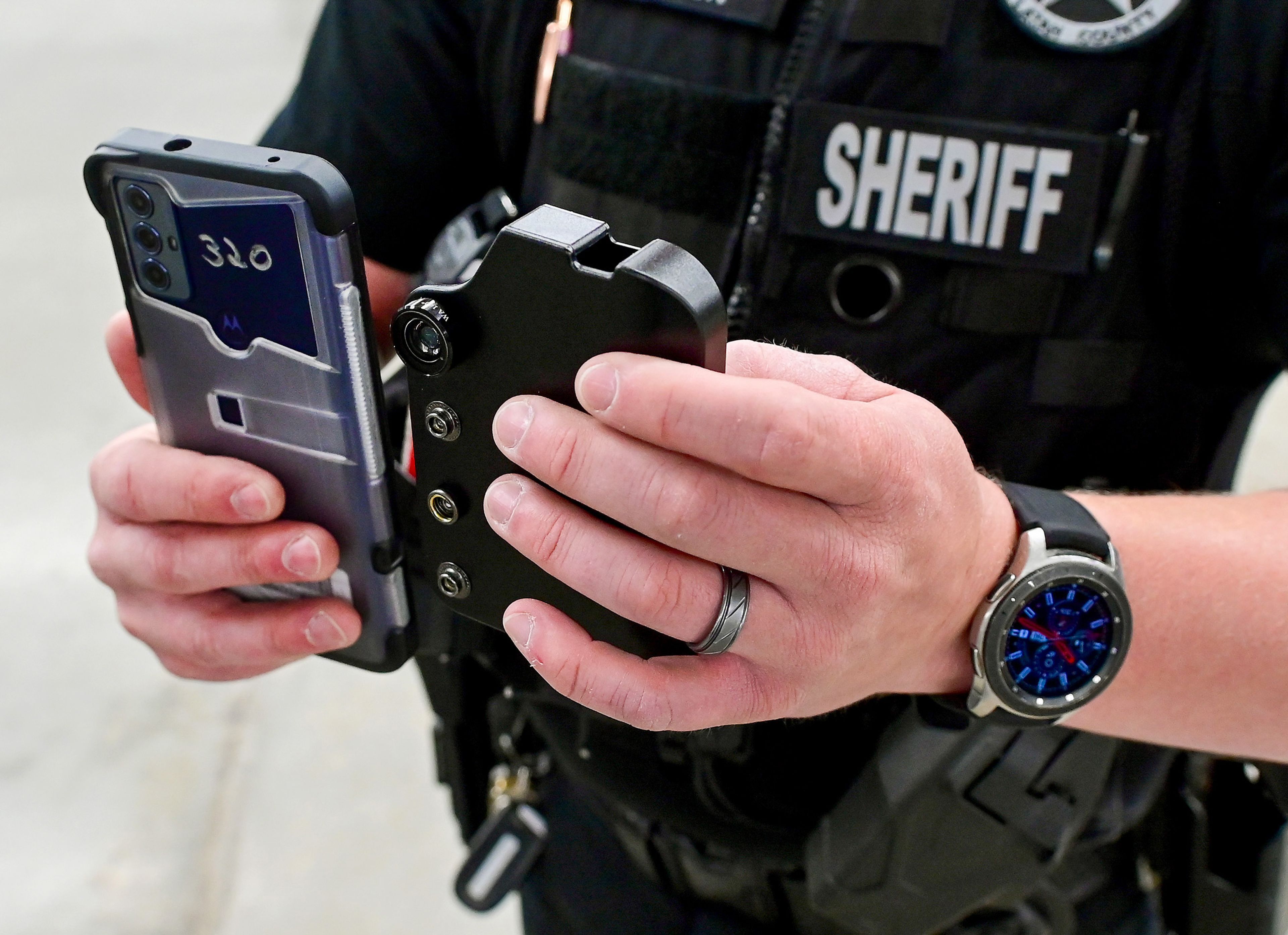 The body camera, left, fits inside of a case secured inside of Latah County Sheriff’s Office deputies vests to operate hands-free, the sheriff’s office shared on Thursday.