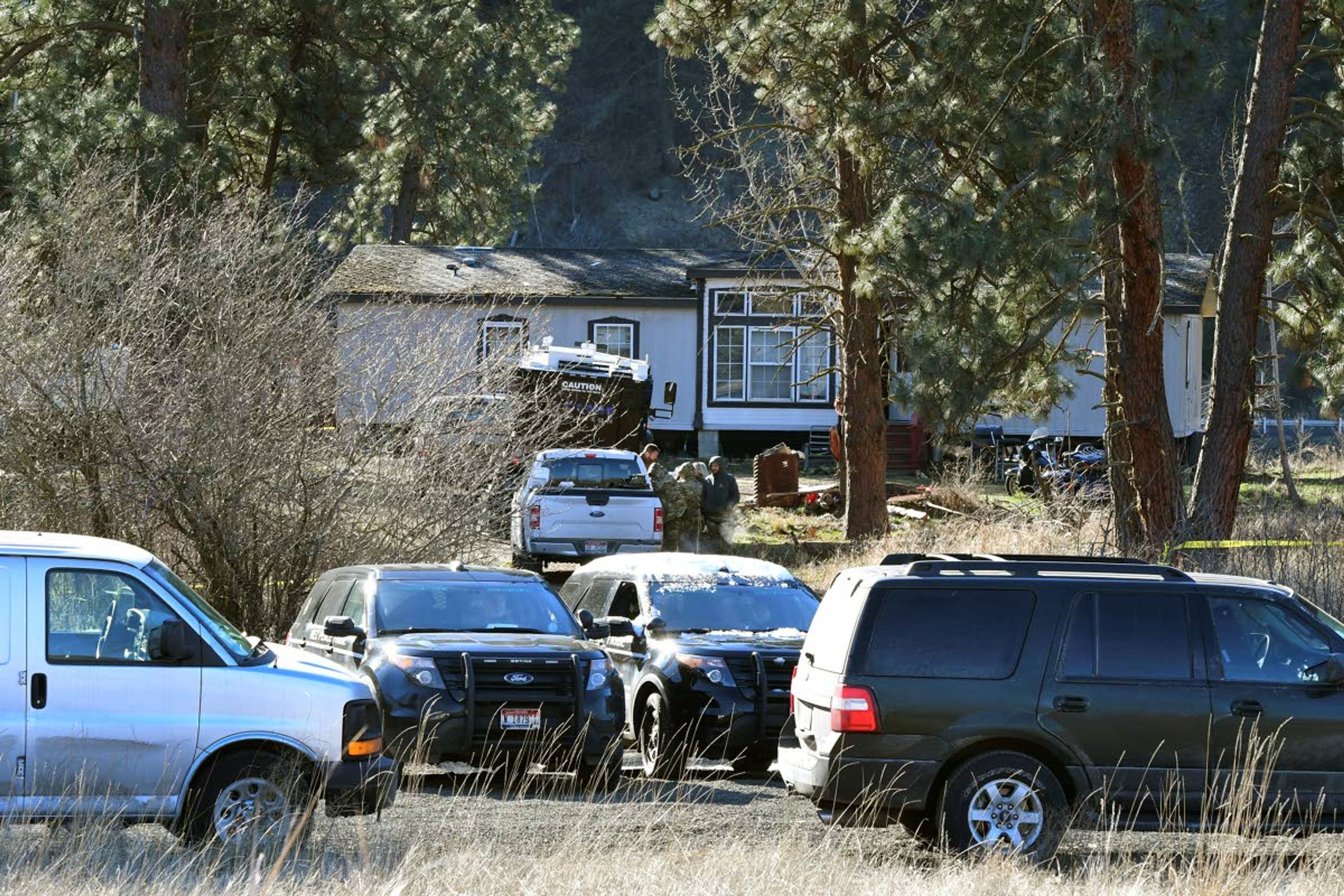 ABOVE: FBI agents and officers from other law enforcement agencies investigate after an FBI agent was shot Thursday morning approximately 22 miles east of Lewiston at Cherrylane.