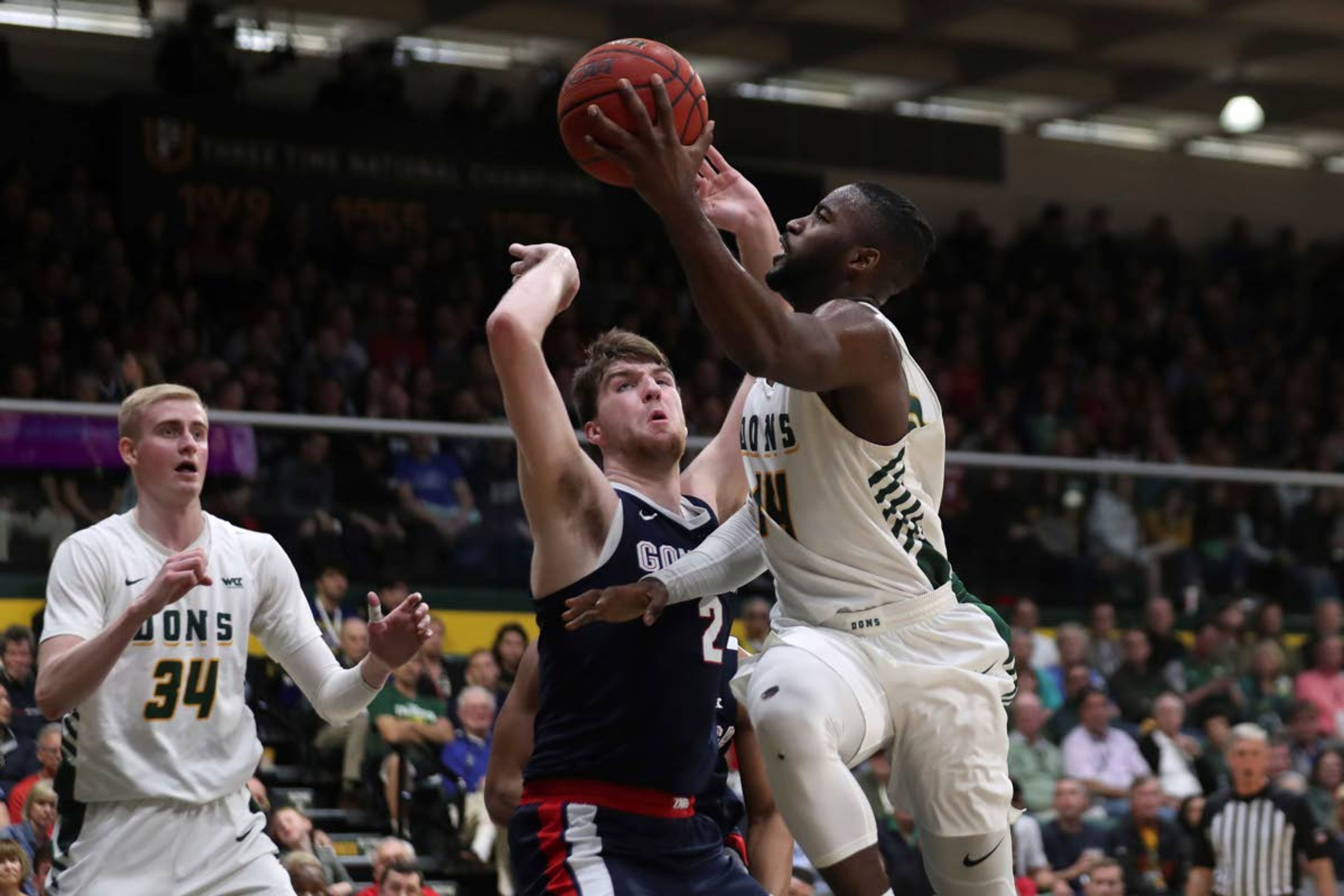 San Francisco guard Charles Minlend (14) shoots against Gonzaga forward Drew Timme (2) during the first half of an NCAA college basketball game in San Francisco, Saturday, Feb. 1, 2020. (AP Photo/Jed Jacobsohn)