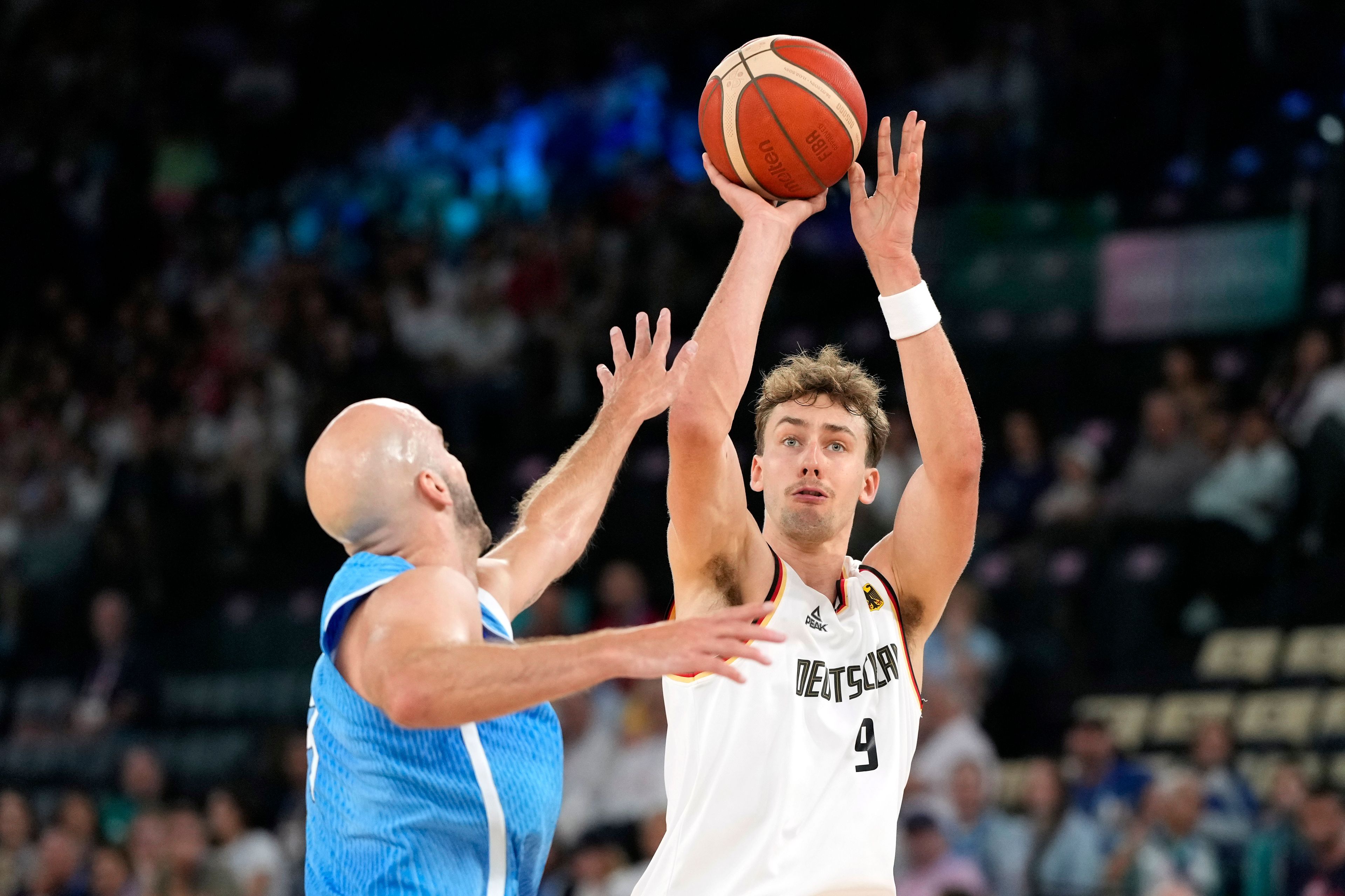 Franz Wagner, right, of Germany, shoots as Nick Calathes, of Greece, defends during a men's basketball game at the 2024 Summer Olympics, Tuesday, Aug. 6, 2024, in Paris, France. (AP Photo/Michael Conroy)