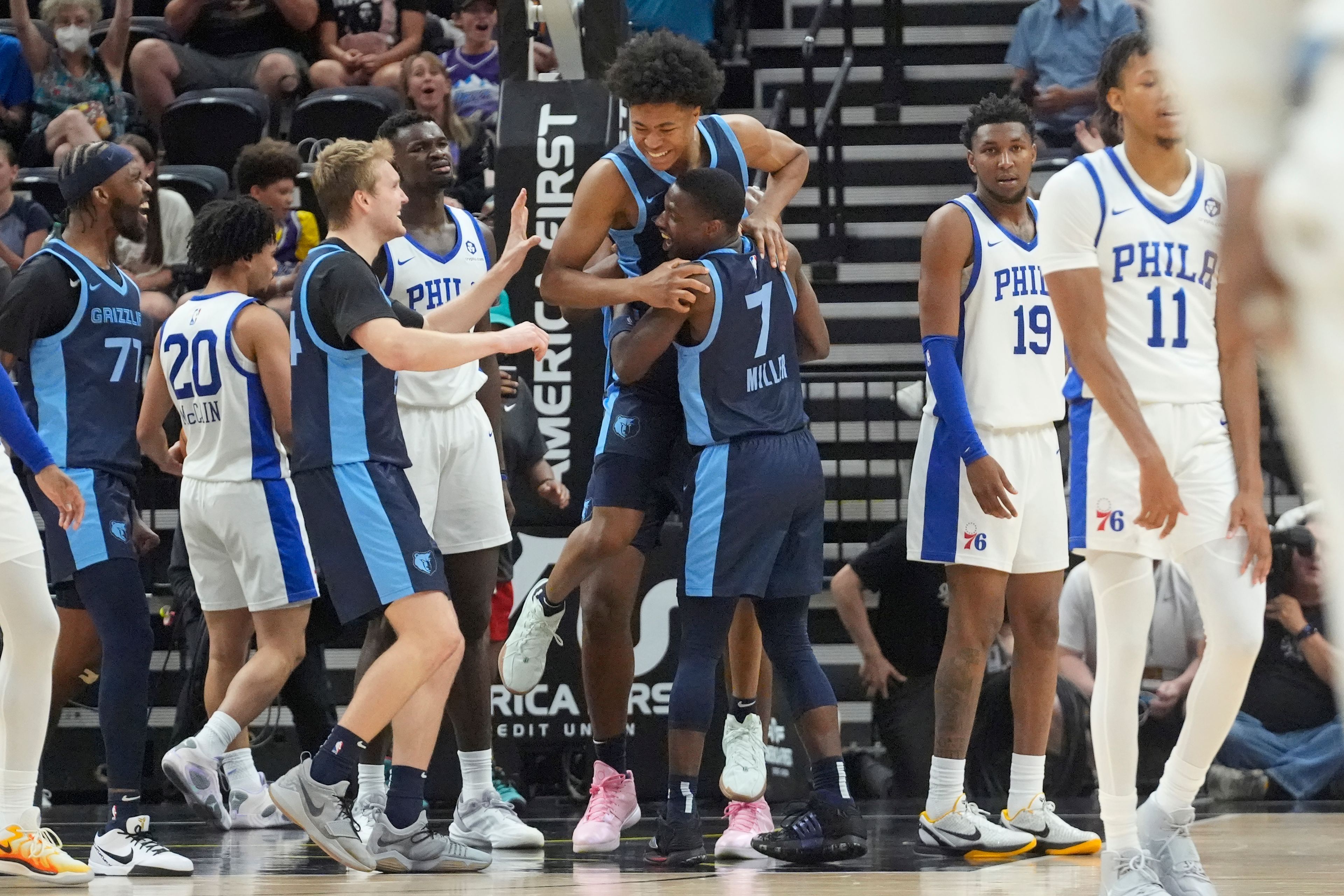 Memphis Grizzlies' Jaylen Wells, top center, is lifted into the air by teammate Isaiah Miller (7) after scoring the winning shot against the Philadelphia 76ers during the second half of an NBA summer league basketball game Tuesday, July 9, 2024, in Salt Lake City. (AP Photo/Rick Bowmer)