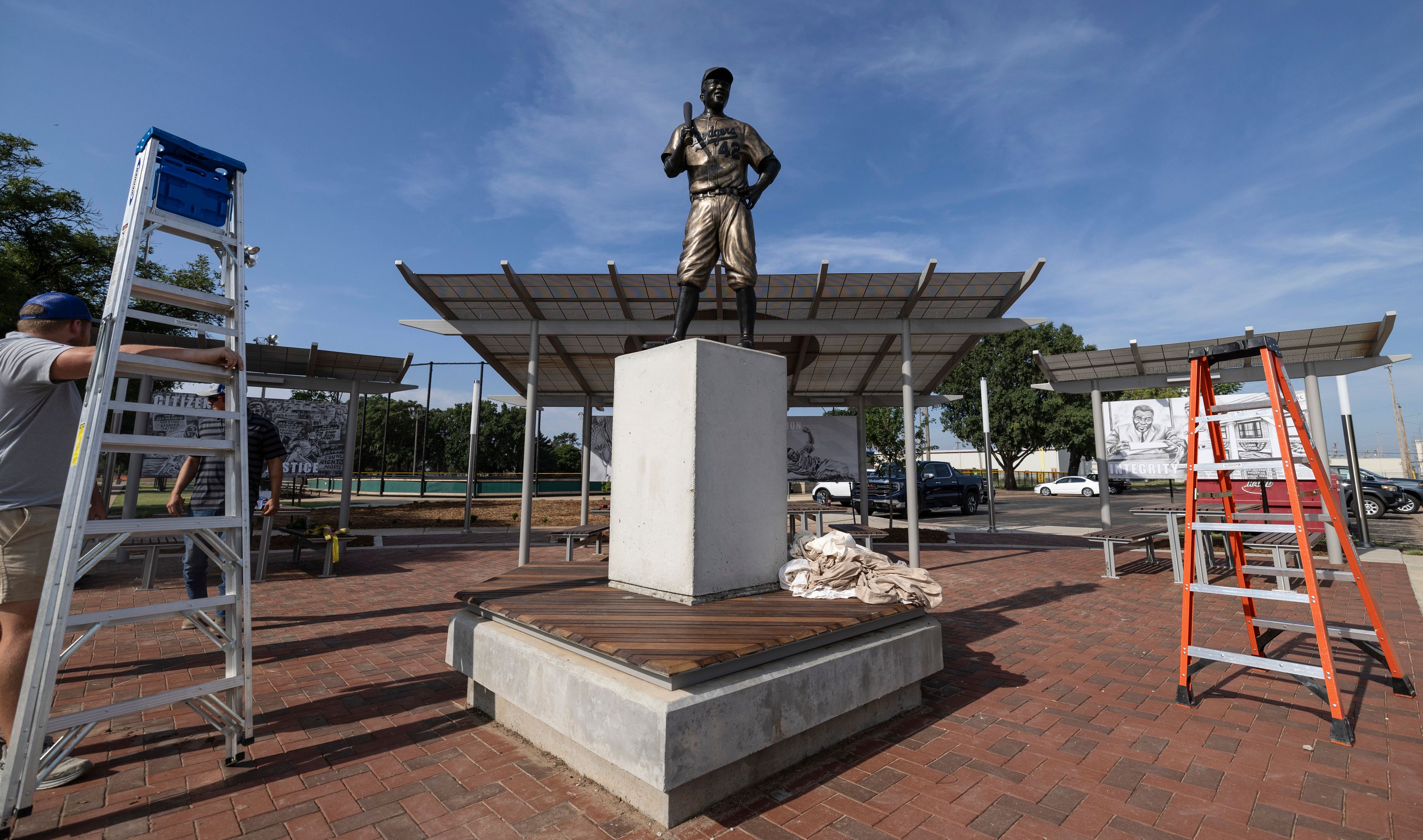 A statue of baseball hall-of-famer and civil rights pioneer Jackie Robinson sits atop a pedestal after is was installed at the League 42 baseball facility in Wichita, Kan., on Friday, Aug. 2, 2024. (Travis Heying/The Wichita Eagle via AP)