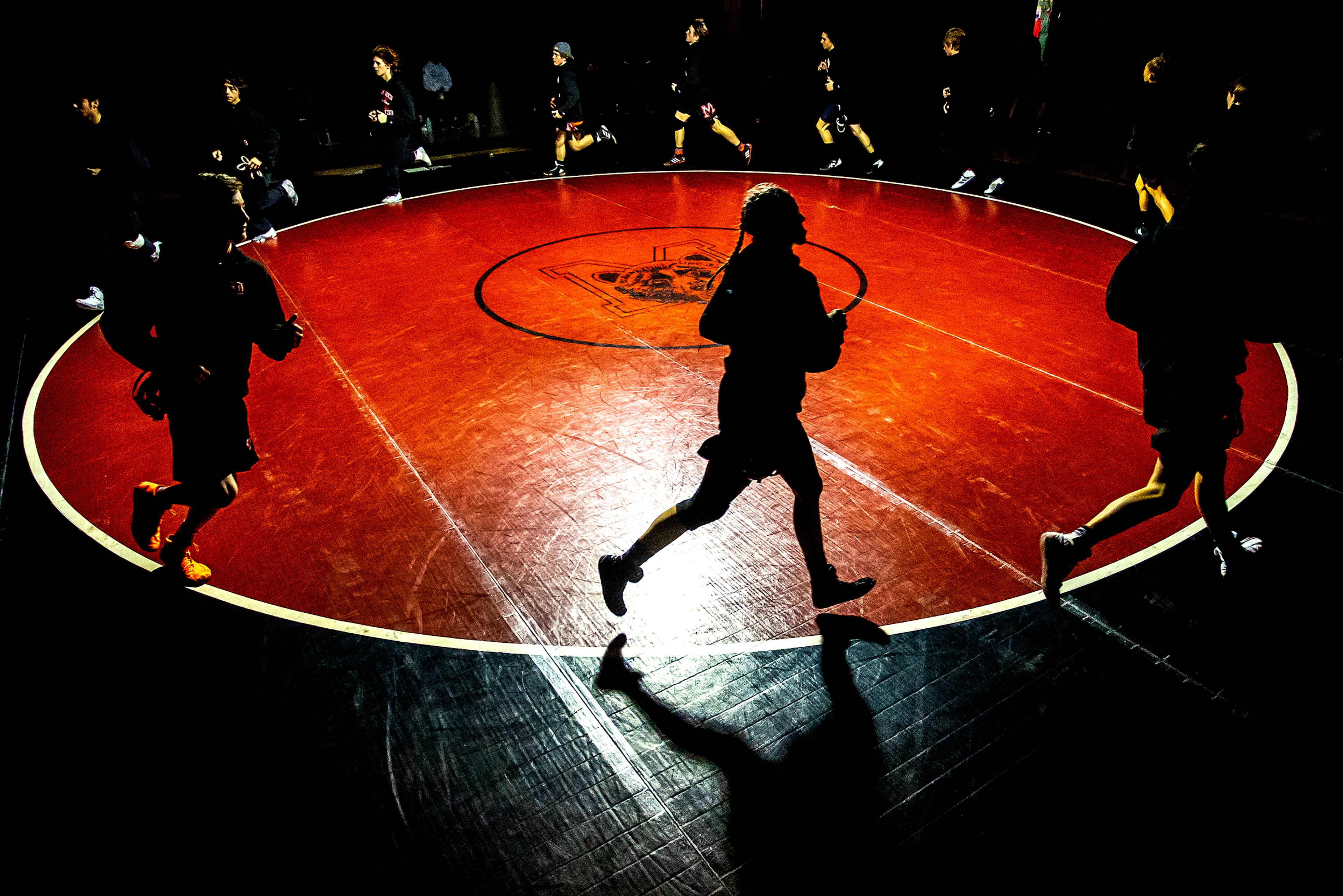 Moscow wrestlers run around the ring prior to their match against Lewiston on Saturday.