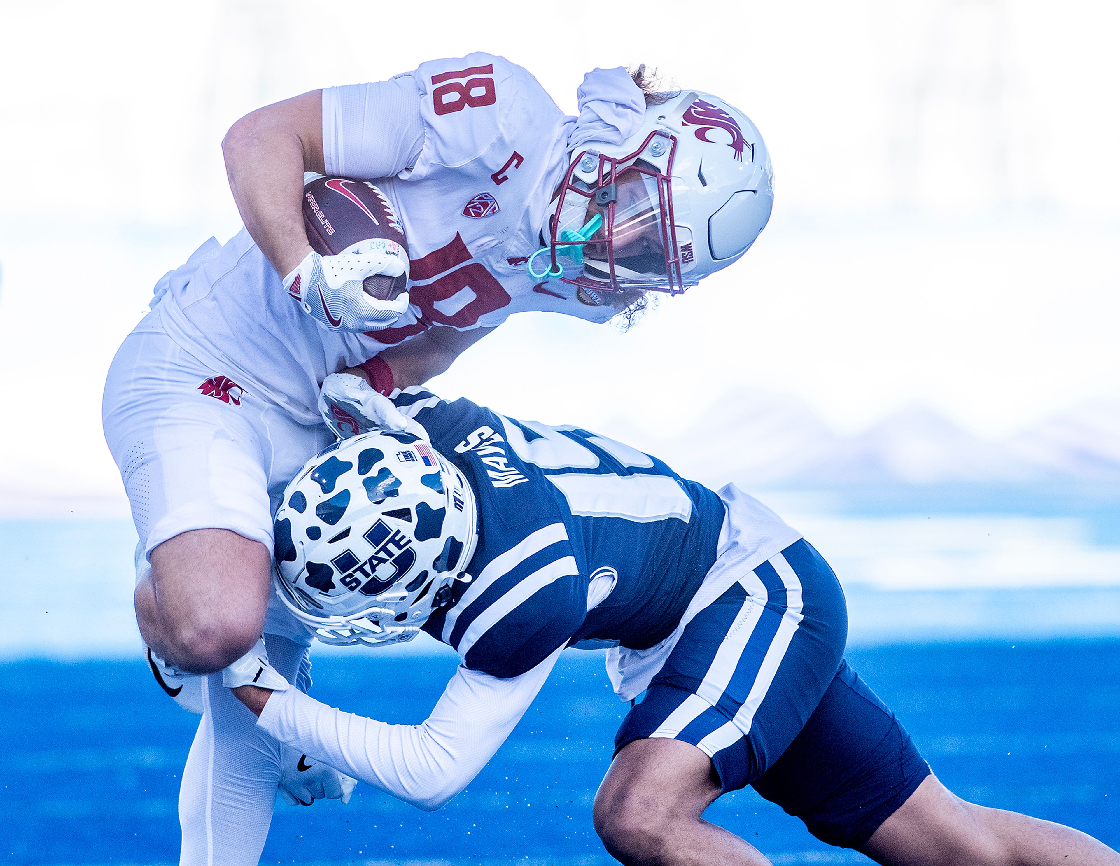 Washington State wide receiver Joshua Meredith is tackled by Utah State cornerback D' Angelo Mayes during the Famous Idaho Potato Bowl Monday at Albertsons Stadium in Boise.