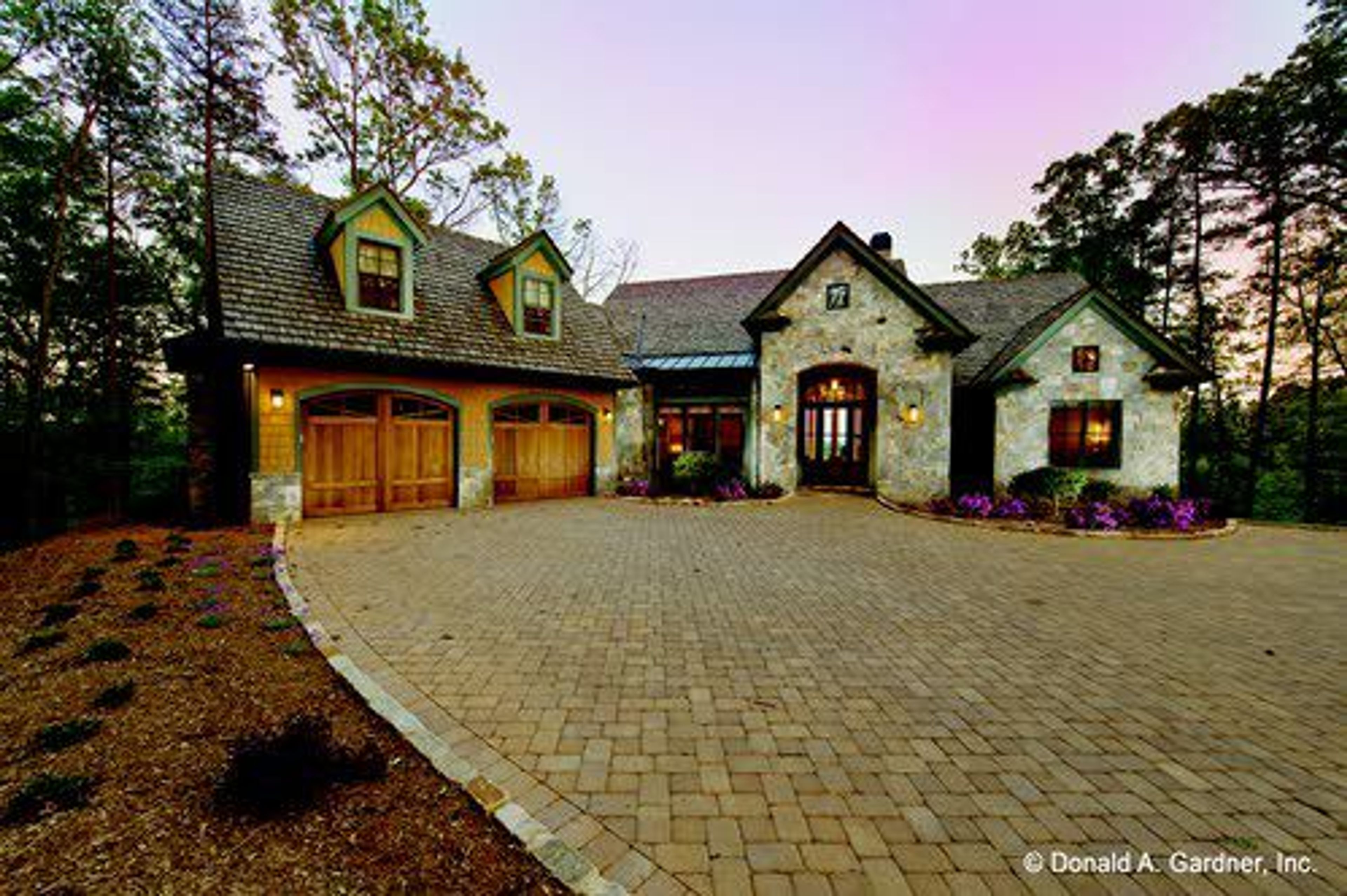 A stone-covered arch draws all eyes to this elegant exterior.