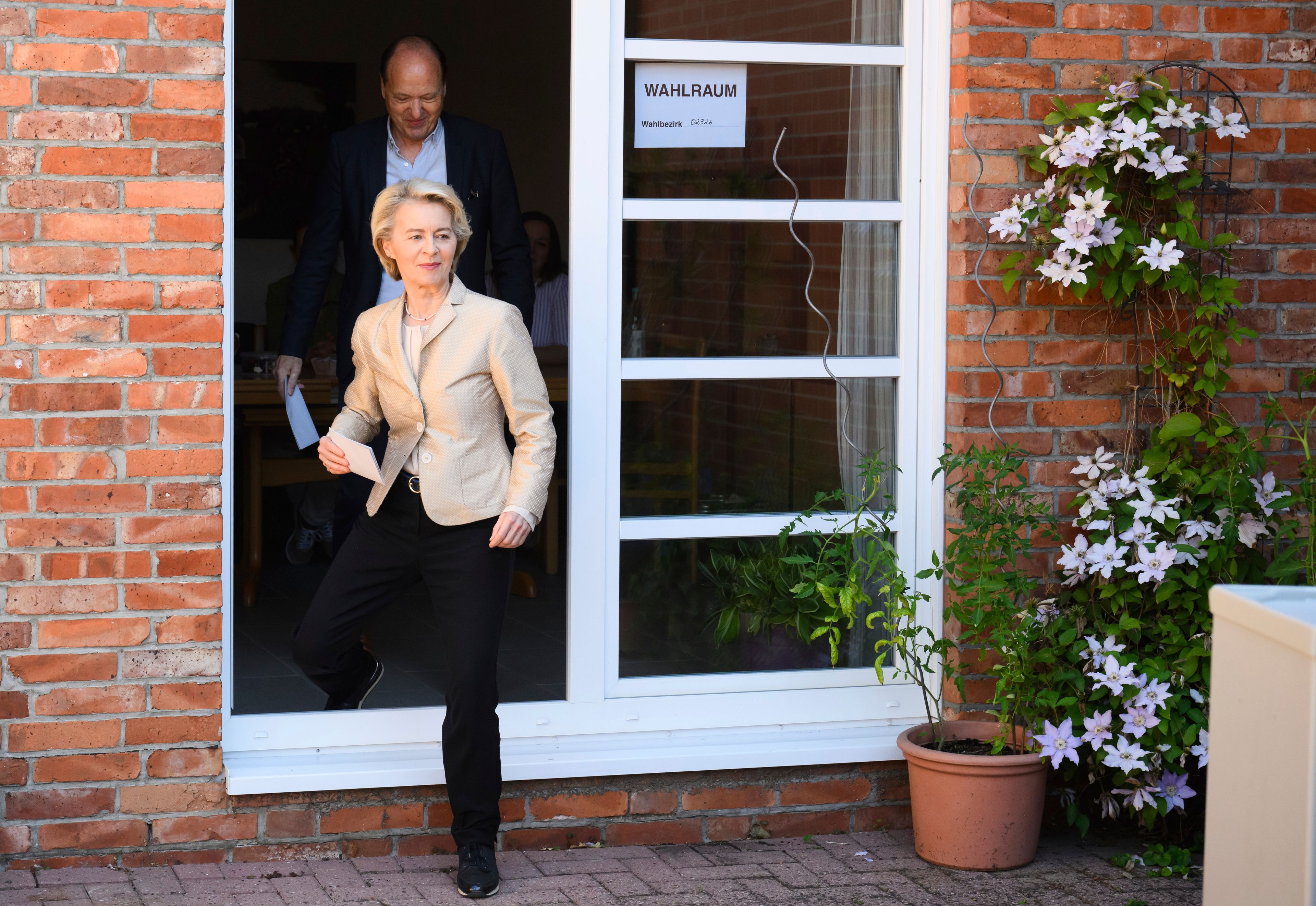 Ursula von der Leyen, left, President of the European Commission, walks to a ballot box outside a polling station in the Hanover region with her husband Heiko to cast her vote in the European Parliament elections, in Burgdorf, Germany on Sunday, June 9, 2024.