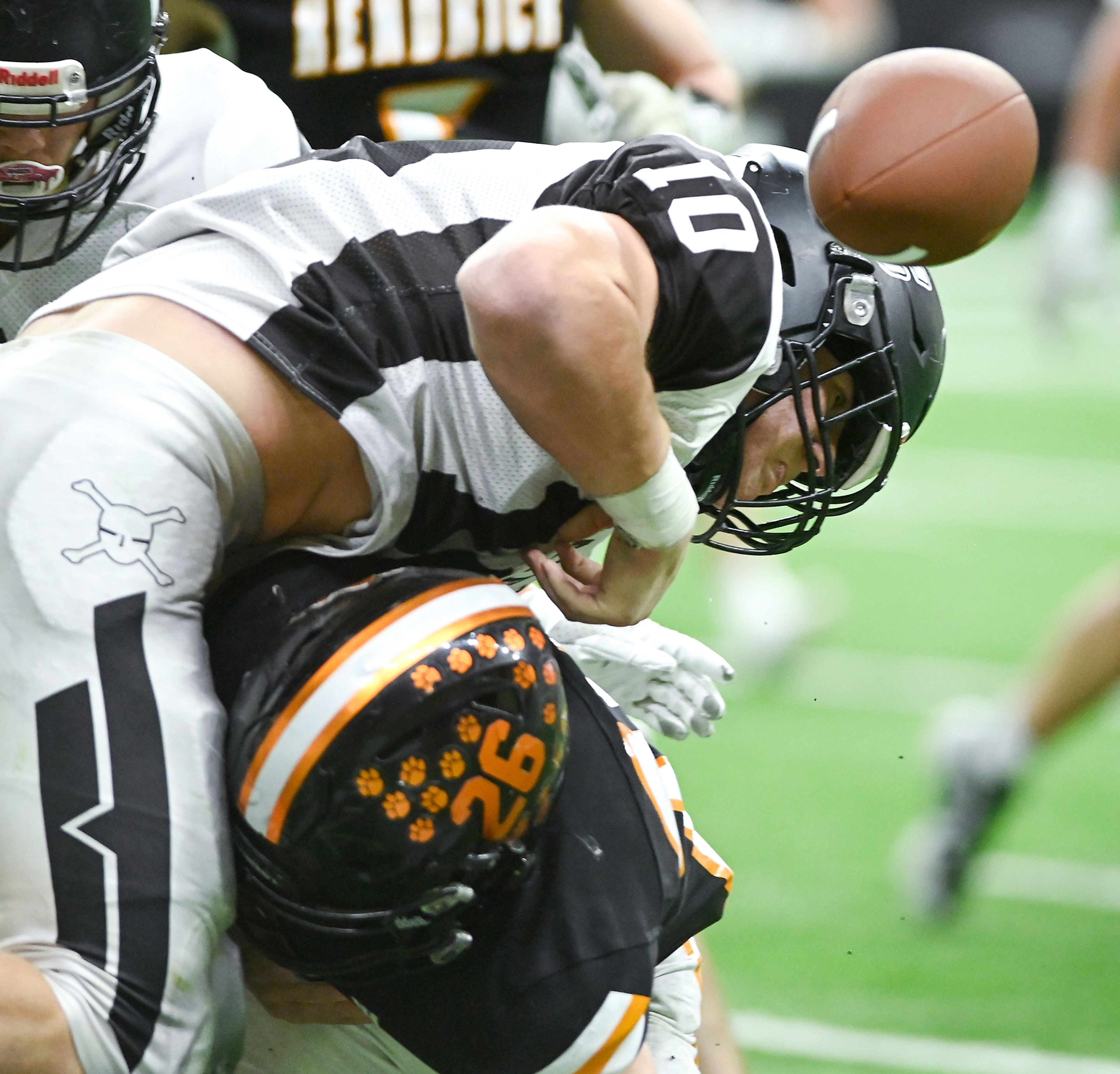 Kendrick’s Orion Stewart tackles Butte County’s Rawson Twitchell, knocking the ball from Twitchell’s hands Friday during the Idaho 2A football state championship game at the P1FCU Kibbie Dome in Moscow.