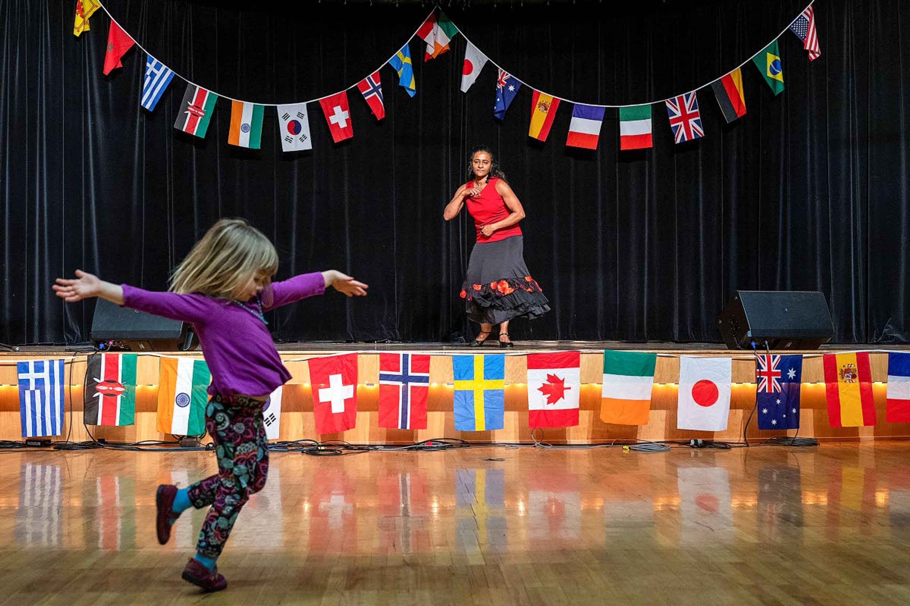 Sandra Gallardo Cook does a Panamanian dance while Luna Heward, 3, of Moscow, does her best interpretation as Cook kicks off the performance portion of the University of Idaho’s Cruise the World 2020 event on Saturday at the Pitman Center in Moscow.