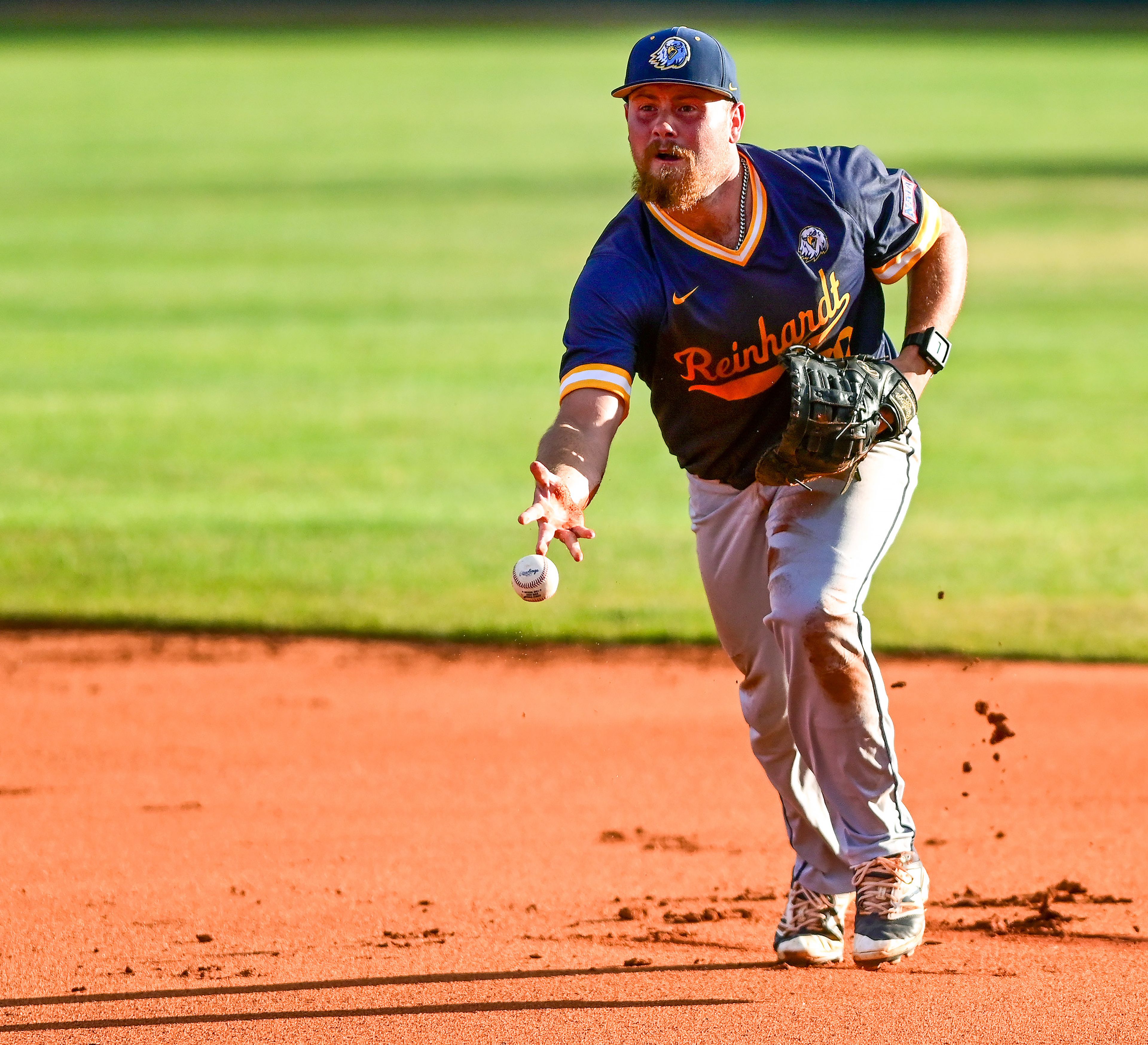 Reinhardt first baseman Nash Crowell throws the ball to first base after diving for a ground ball for an out against Tennessee Wesleyan in Game 18 of the NAIA World Series at Harris Field in Lewiston on Thursday.