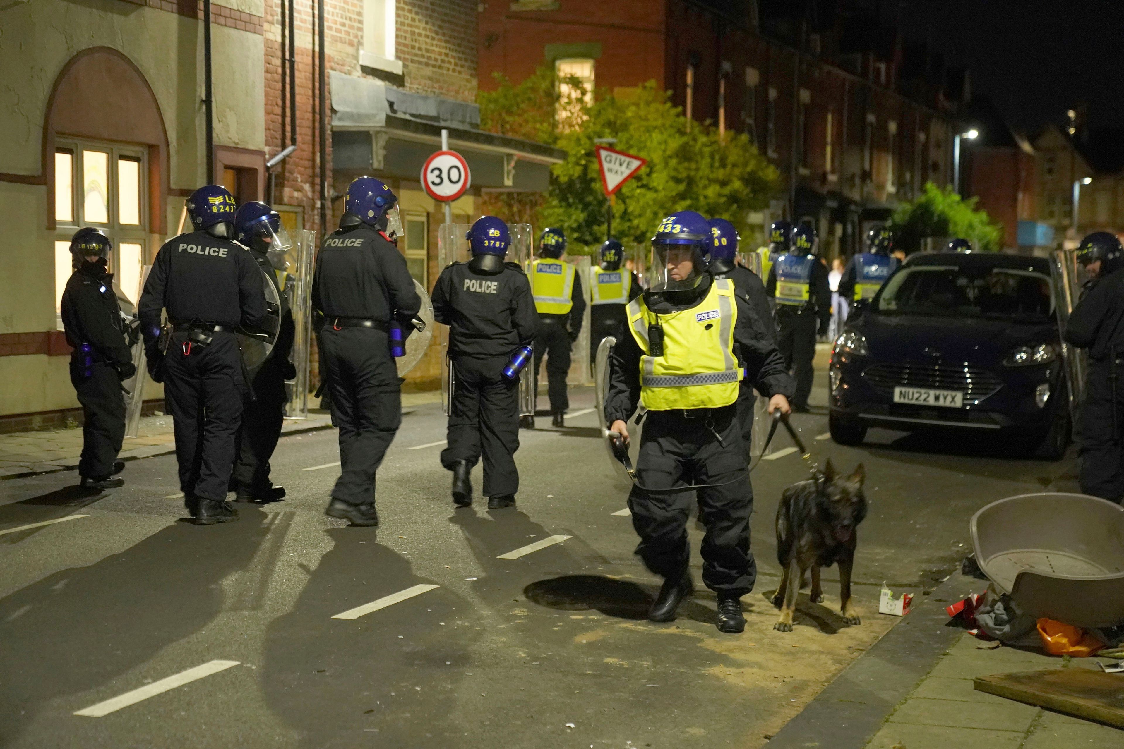 Police officers are deployed on the streets of Hartlepool, England, following a violent protest in the wake of the killing of three girls who were fatally stabbed in northwest England, Wednesday, July 31, 2024. (Owen Humphreys/PA via AP)