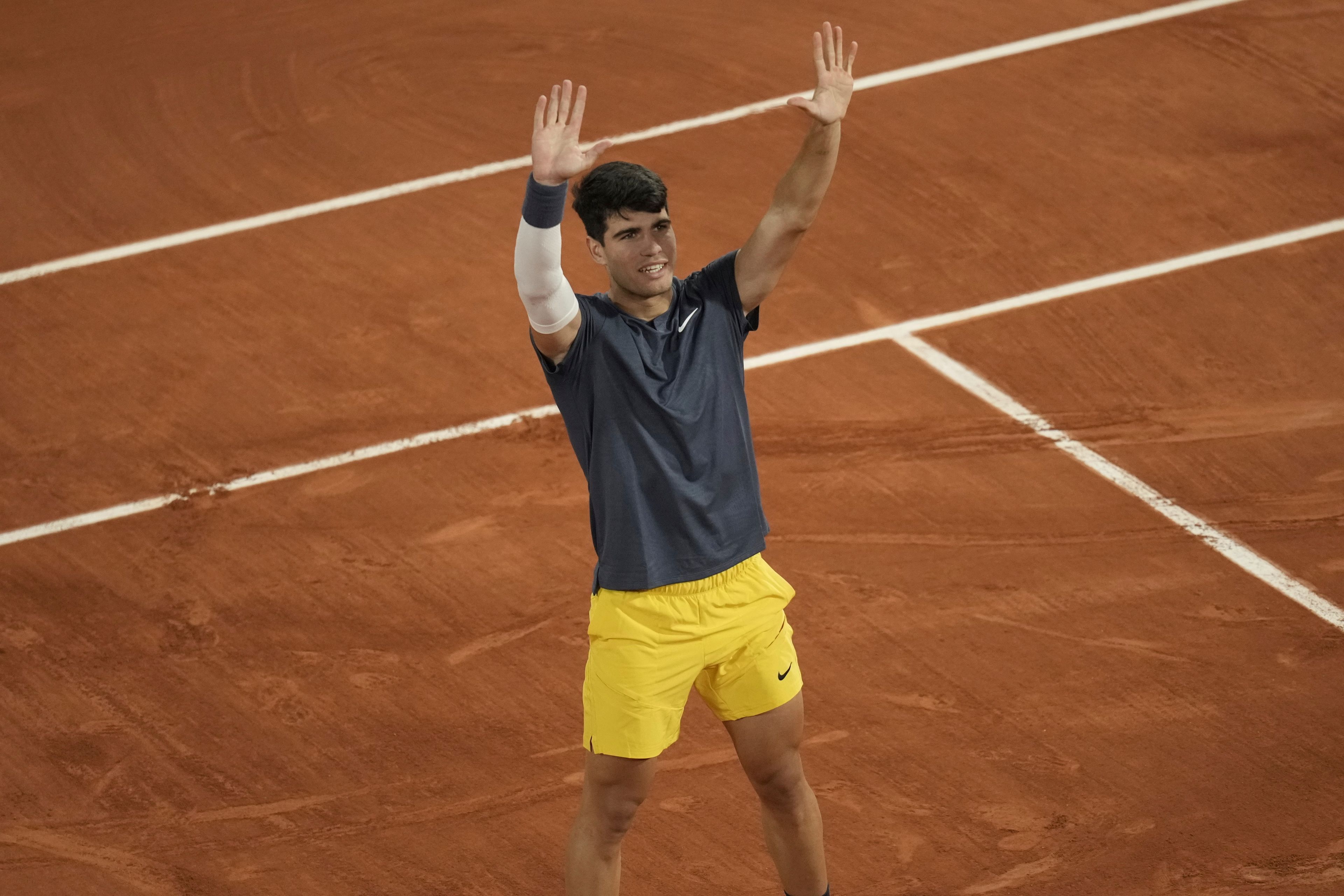 Spain's Carlos Alcaraz celebrates as he won the quarterfinal match of the French Open tennis tournament against Greece's Stefanos Tsitsipas at the Roland Garros stadium in Paris, Tuesday, June 4, 2024.