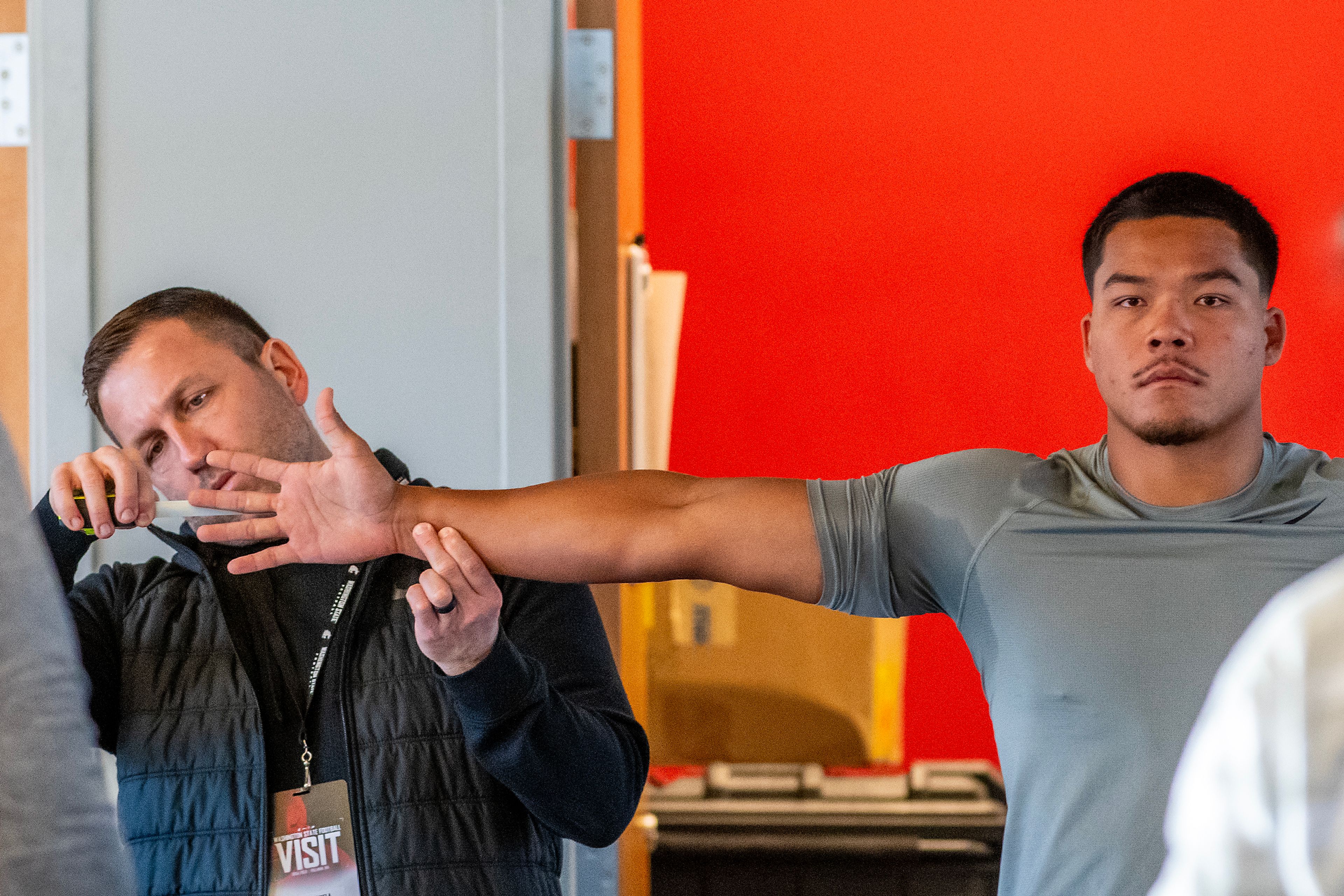 Washington State safety Tanner Moku has measurements taken during WSU's Pro Day on Friday in Pullman.