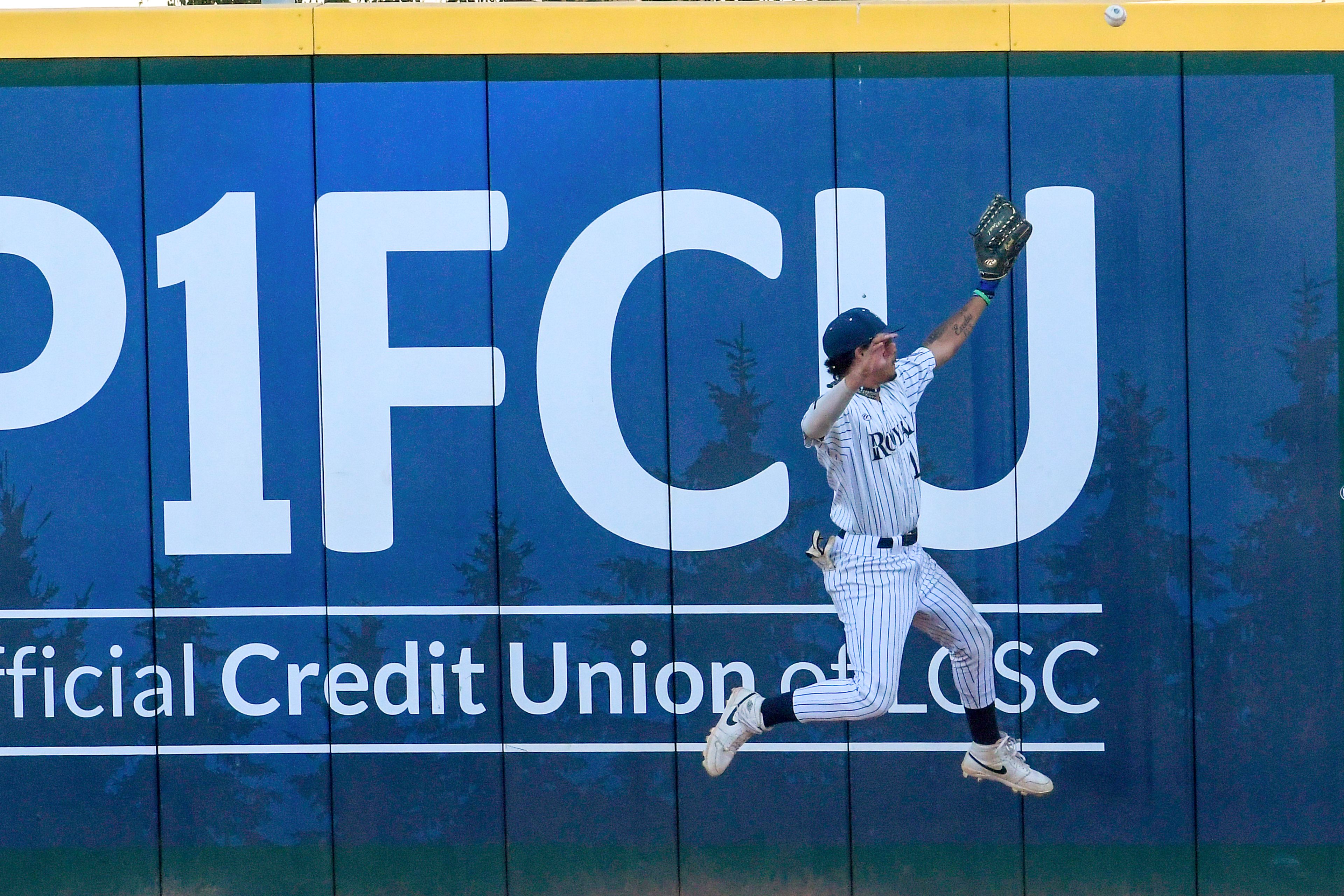 Hope International center fielder Amari Bartee attempts to make a catch against the wall against Tennessee Wesleyan in Game 19 of the NAIA World Series at Harris Field Friday in Lewiston.