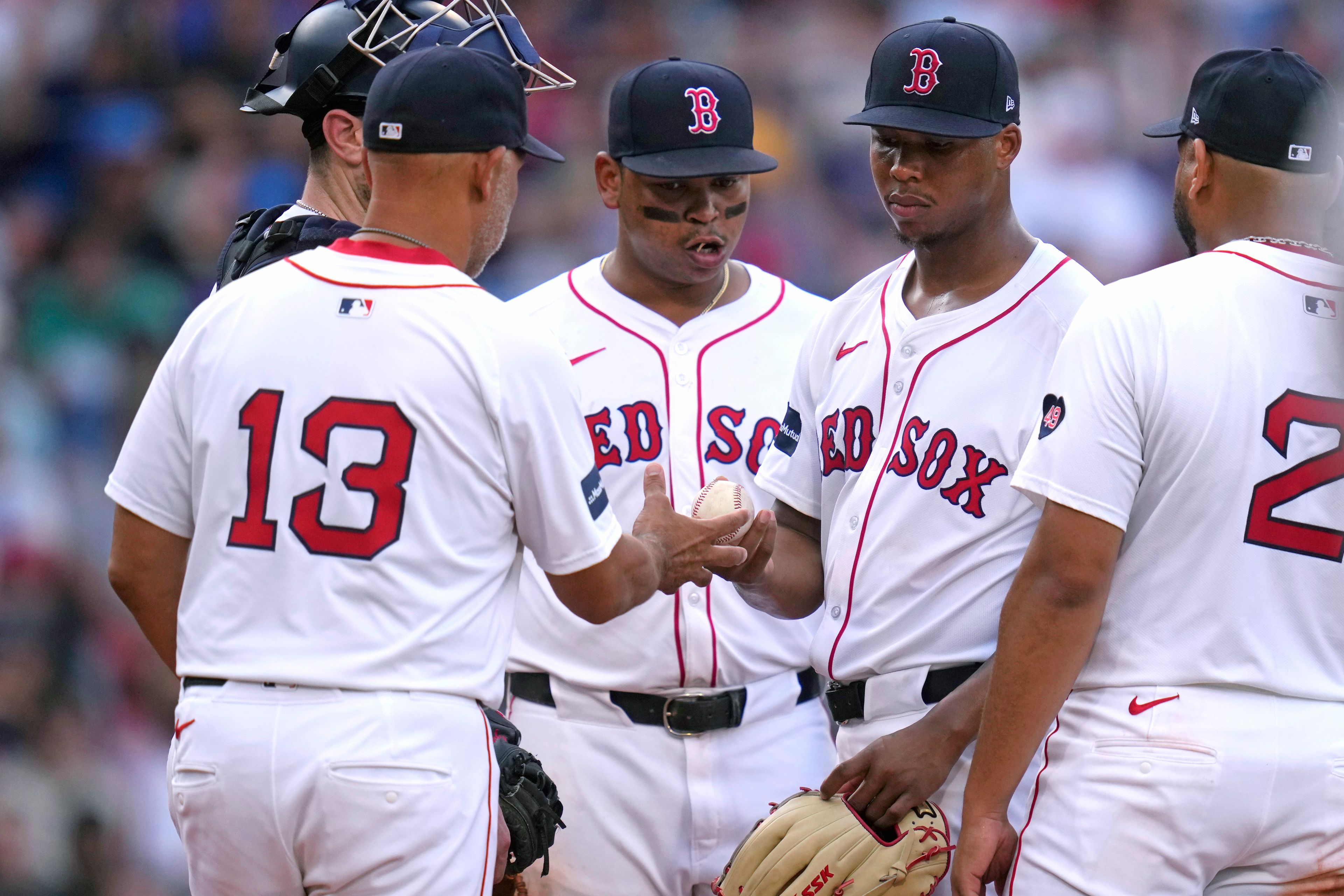 Boston Red Sox pitcher Brayan Bello, right, is pulled by manager Alex Cora (13) during the seventh inning of a baseball game against the Seattle Mariners, Wednesday, July 31, 2024, in Boston. (AP Photo/Charles Krupa)