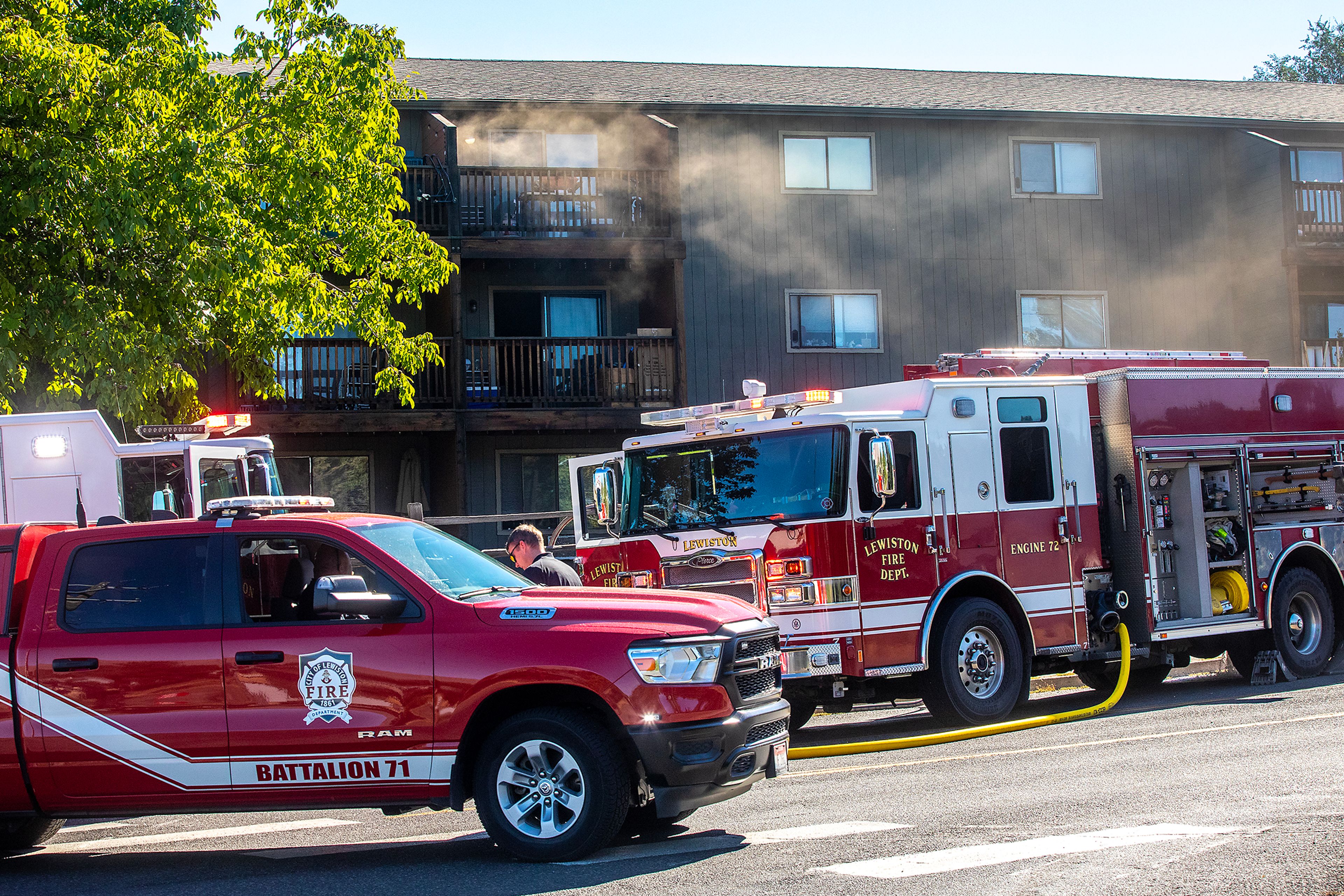 Lewiston firefighters respond to a fire at an apartment complex off Eighth Street as smoke wafts from the building Thursday in Lewiston.