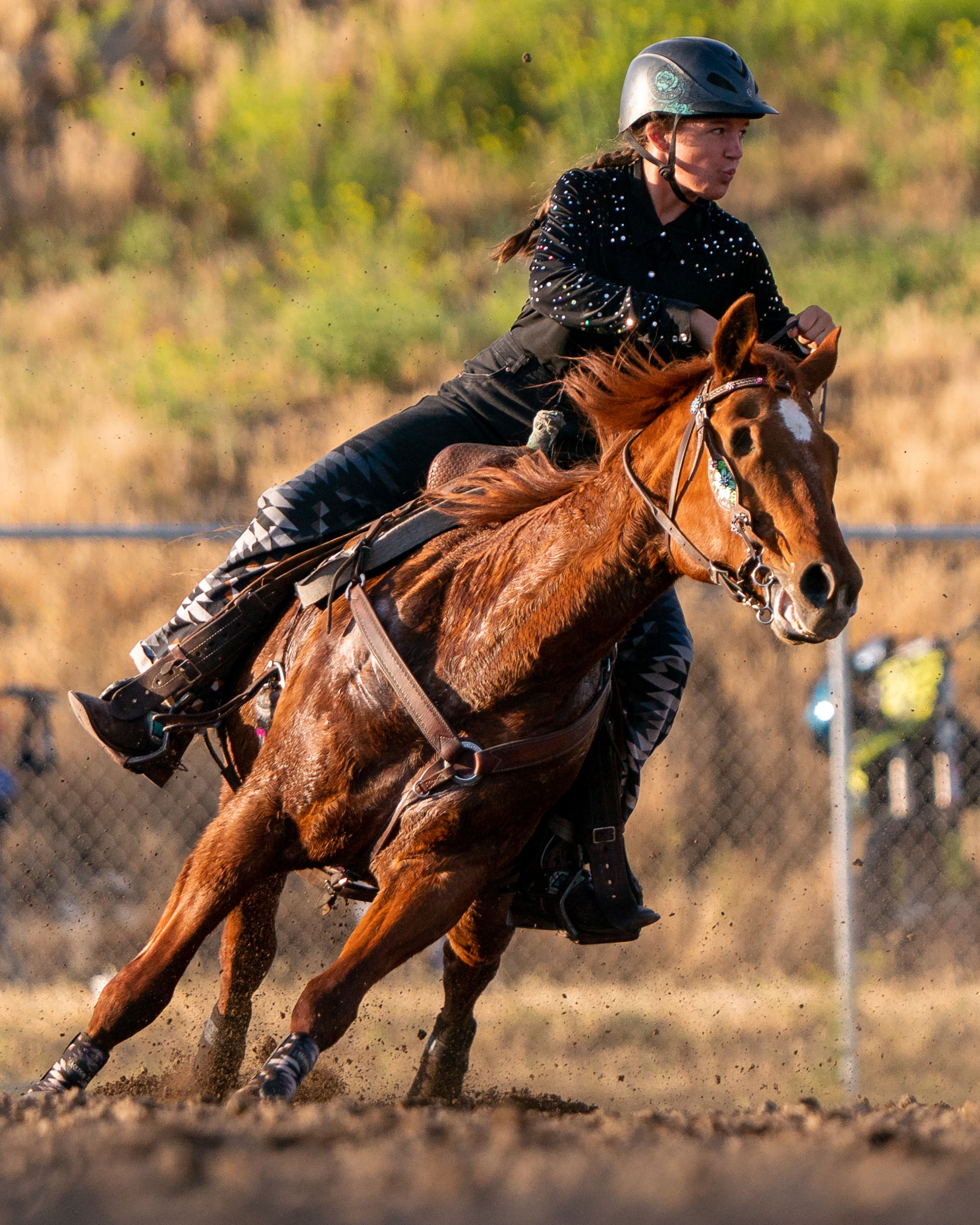 Jana Hartley turns her horse Ruby around a barrel during the Horsepower vs Horse Power event Saturday evening at ECMX Park in Lewiston. Ruby is blind in both eyes.