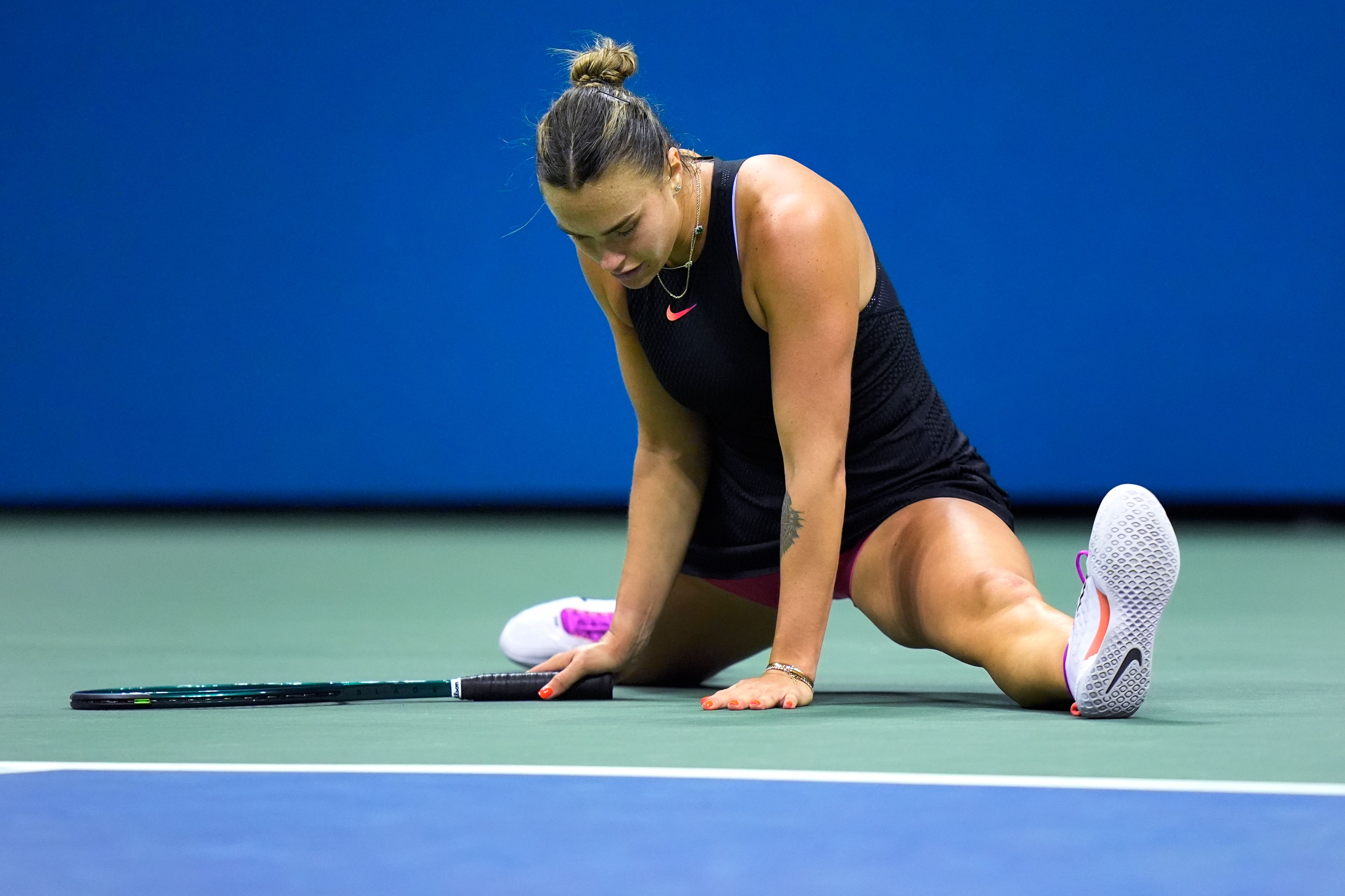 Aryna Sabalenka, of Belarus, does a split after a return against Zheng Qinwen, of China, during the quarterfinals of the U.S. Open tennis championships, Tuesday, Sept. 3, 2024, in New York.