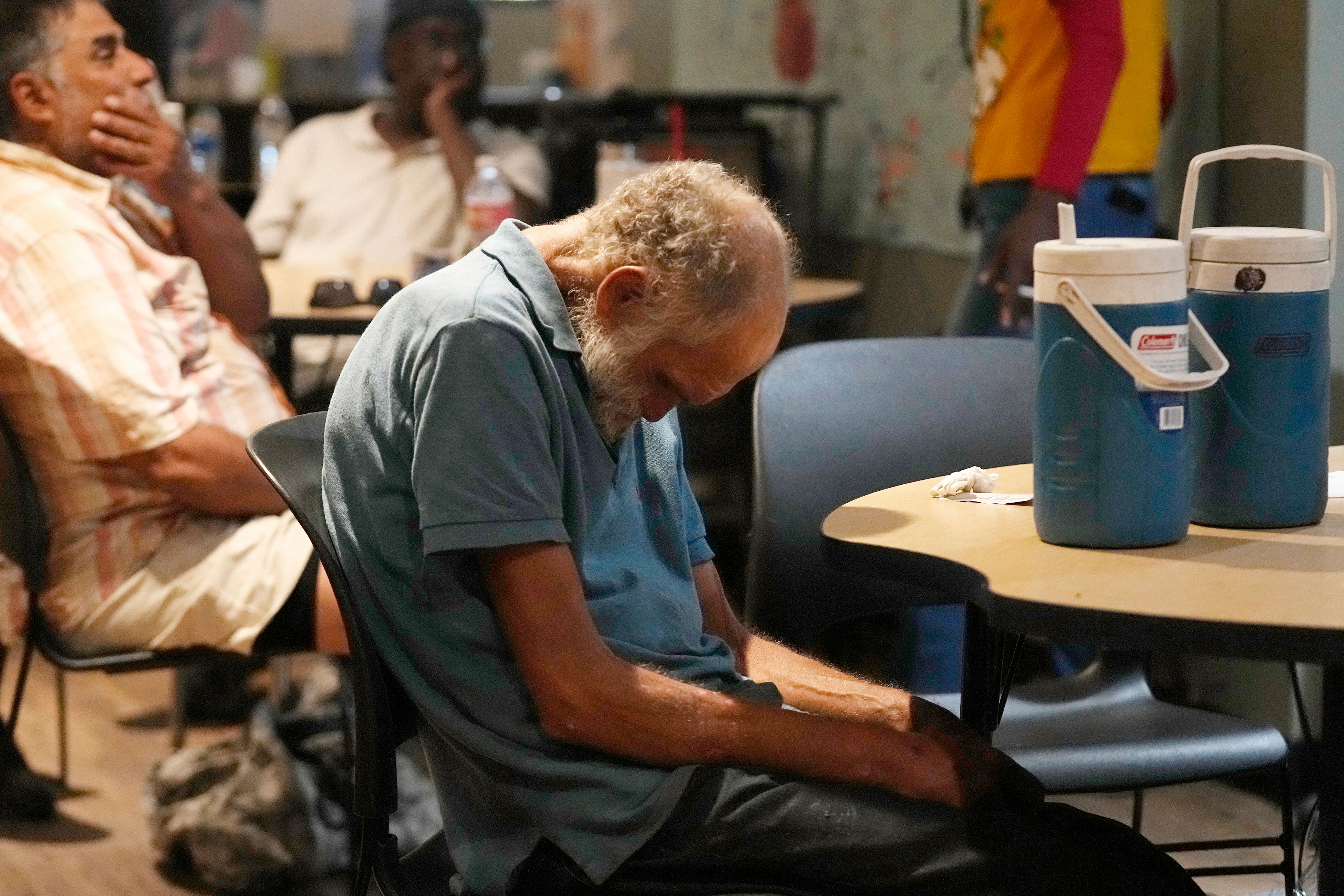 FILE - Patrons try to cool off inside at the Justa Center as temperatures are expected to hit 116 degrees Fahrenheit, on July 18, 2023, in Phoenix. The death certificates of more than 2,300 people who died in the United States last summer mention the effects of excessive heat, the highest number in 45 years of records, according to an Associated Press analysis of Centers for Disease Control and Prevention data. With May already breaking heat records, 2024 could be even deadlier. (AP Photo/Ross D. Franklin, File)