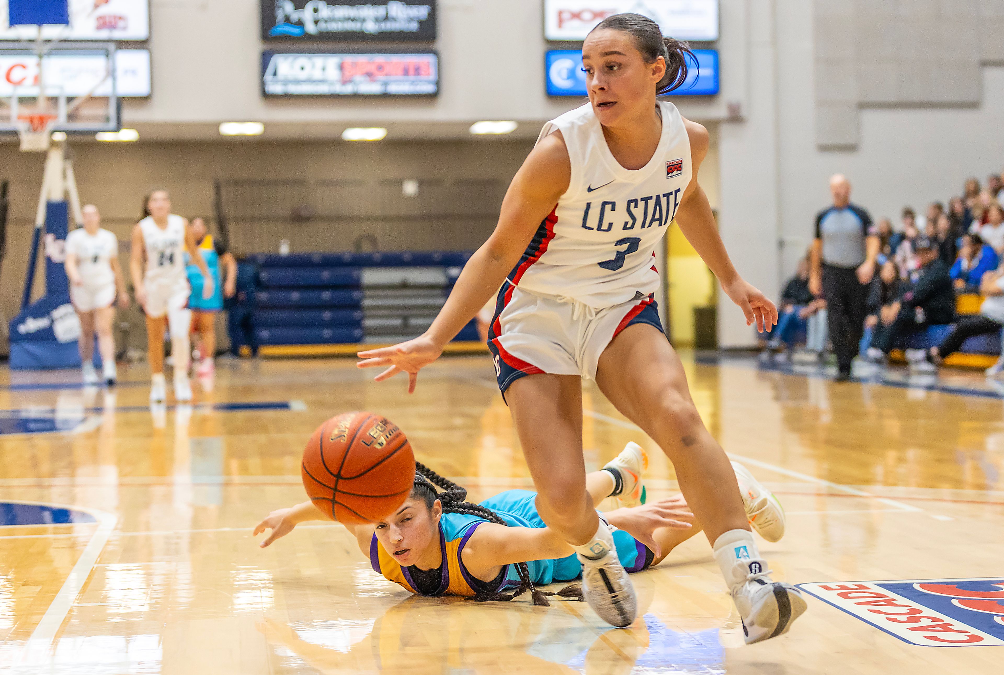 Lewis-Clark State guard Kendall Wallace grabs the ball over Haskell before taking a shot during the season opening game as part of Tribal Nations Weekend Saturday in Lewiston.,