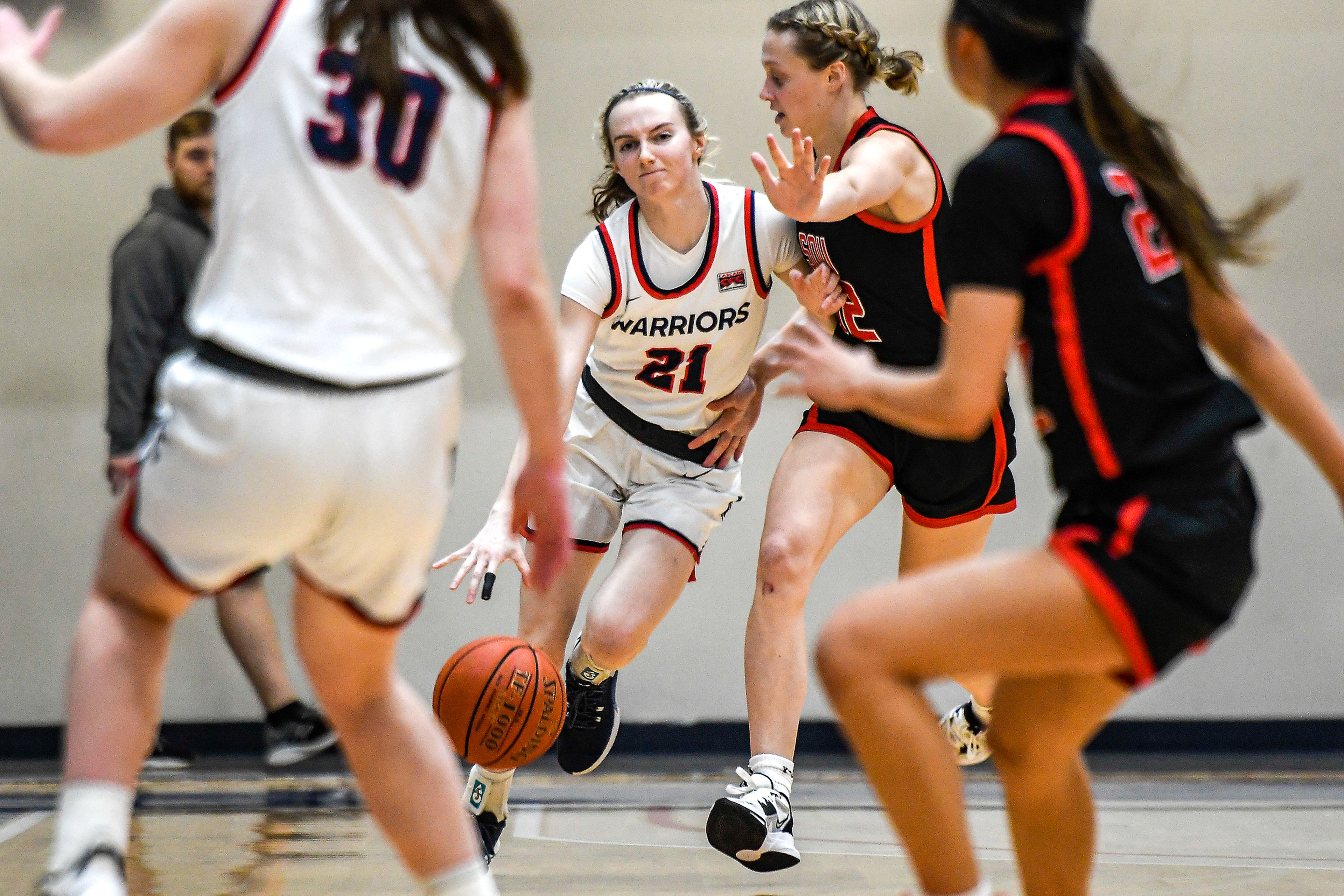 Lewis-Clark State guard Callie Stevens, center, dribbles during Saturday's Cascade Conference game against Southern Oregon at the P1FCU Activity Center.