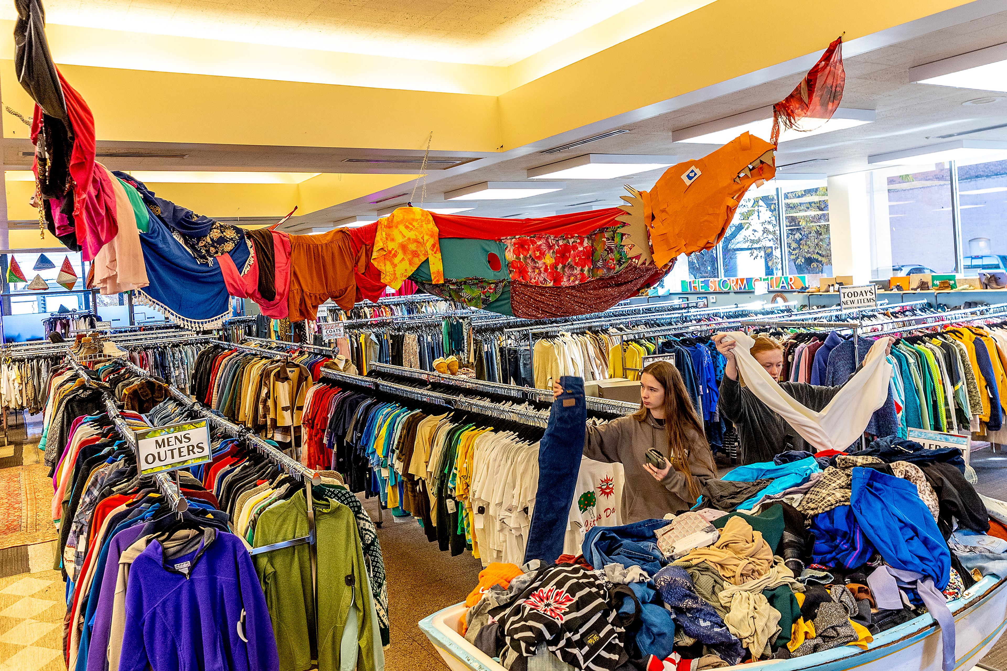 Isabel Blewett, of Lewiston, left, and Addi Weeks, of Lewiston, look through clothes sat Storm Cellar on Plaid Friday in Lewiston.