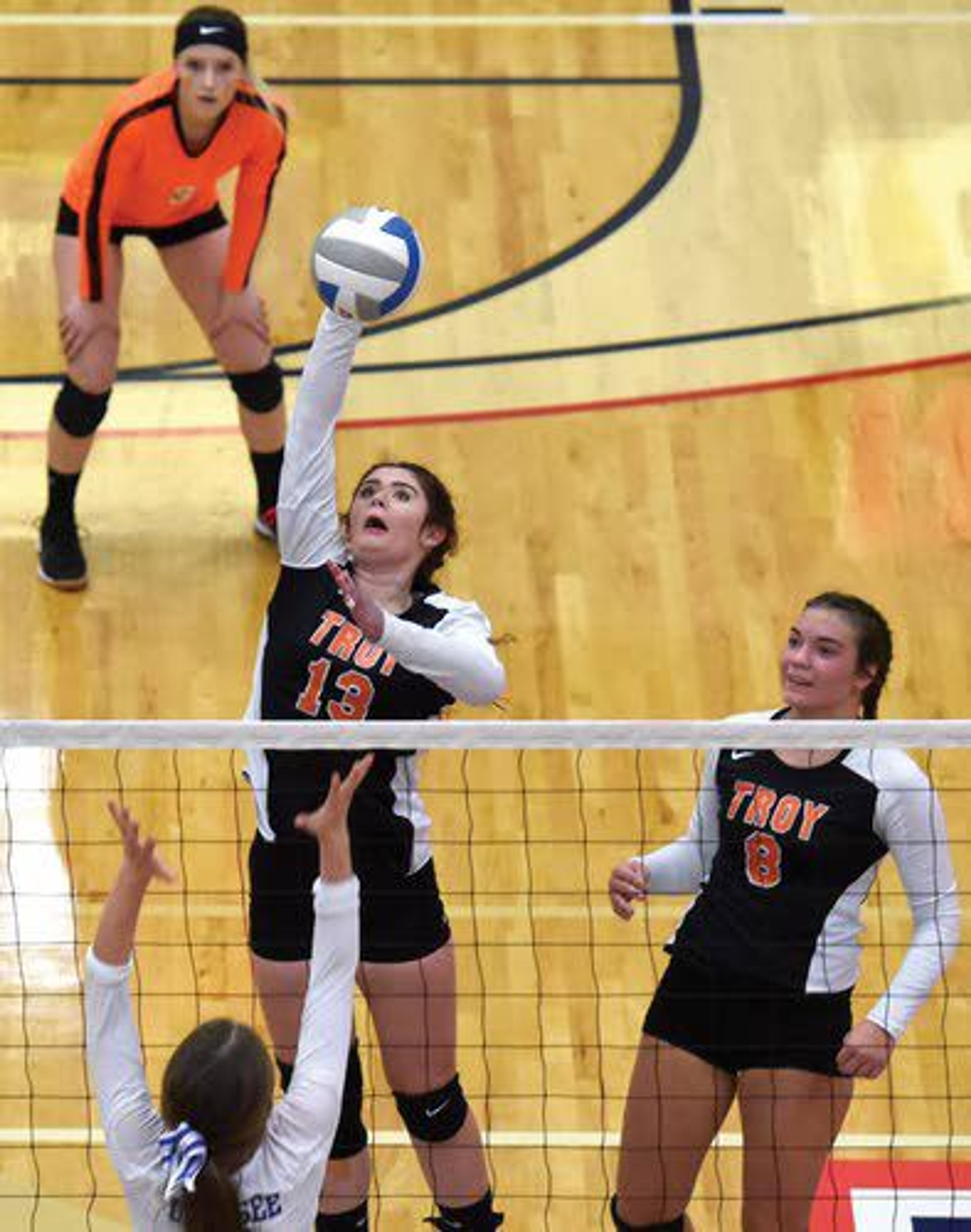 Troy middle hitter Lakota Anderson (13) spikes the ball towards the Genesee side of the net during the second set of the Class 1A Division 1 District II Championship Game on Tuesday night at the Lewis Clark State College Activity Center in Lewiston.