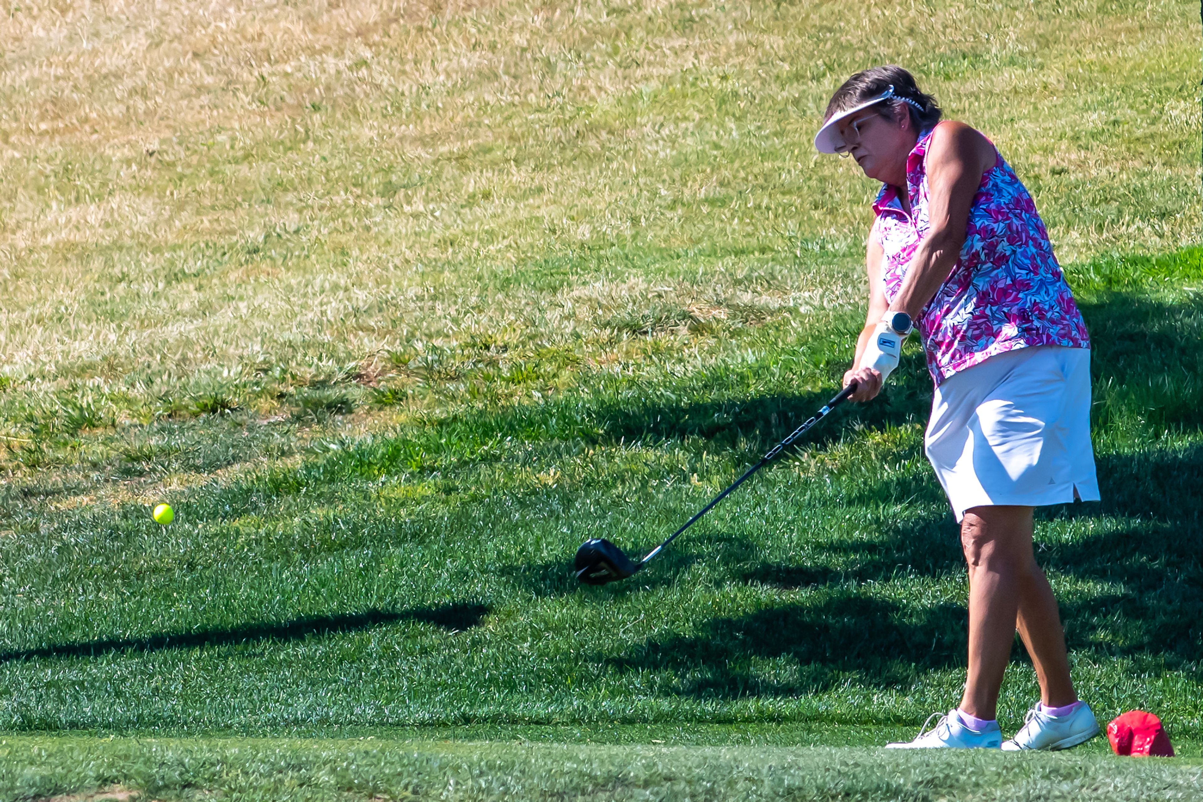 Mary Lauritsen, with Red Wolf, hits her ball during the Tribune Cup golf tournament at Quail Ridge Golf Course on Tuesday in Clarkston.