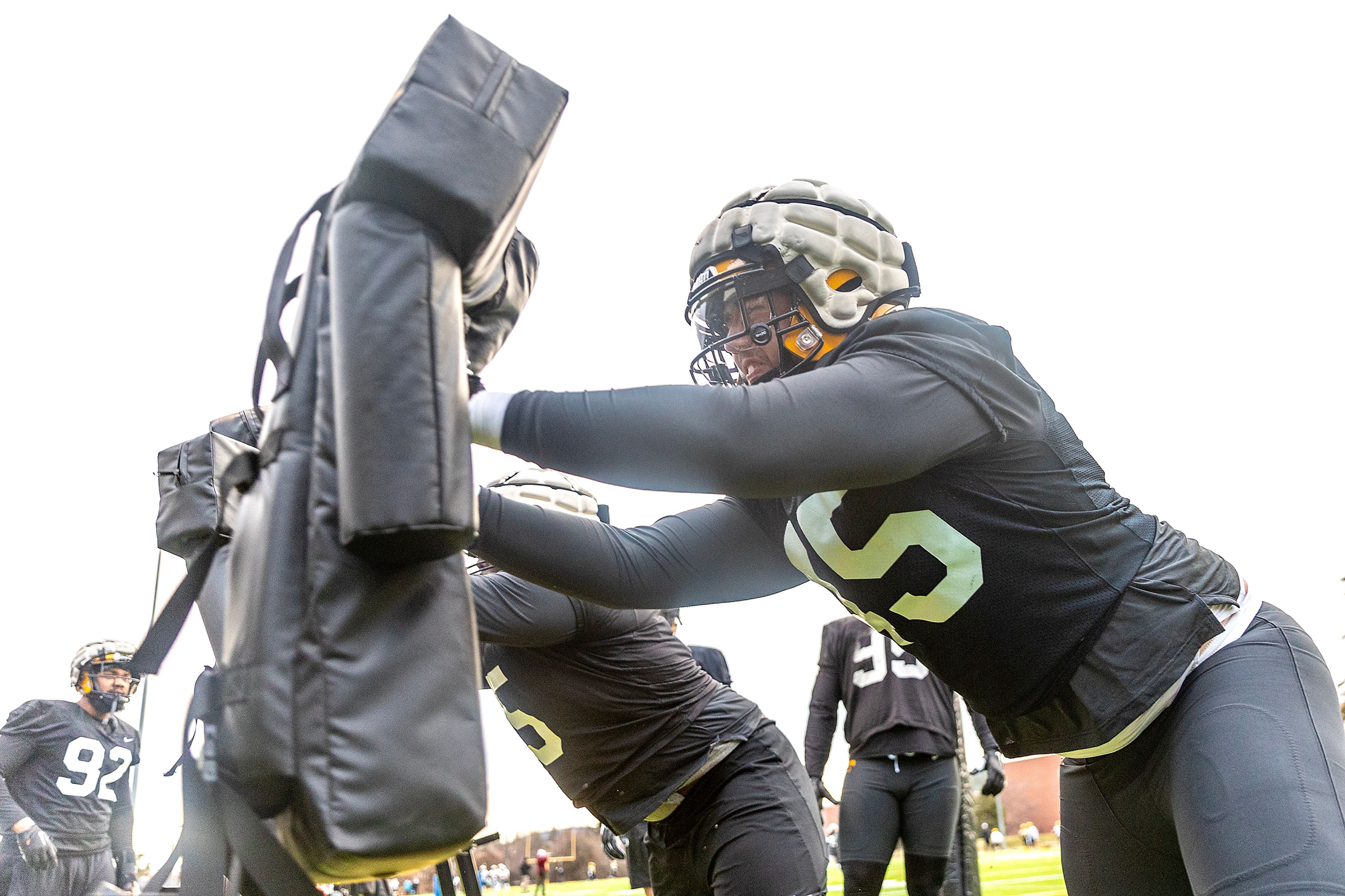 Idaho defensive linemen push up against practice dummies during Idaho’s first spring practice in Moscow.