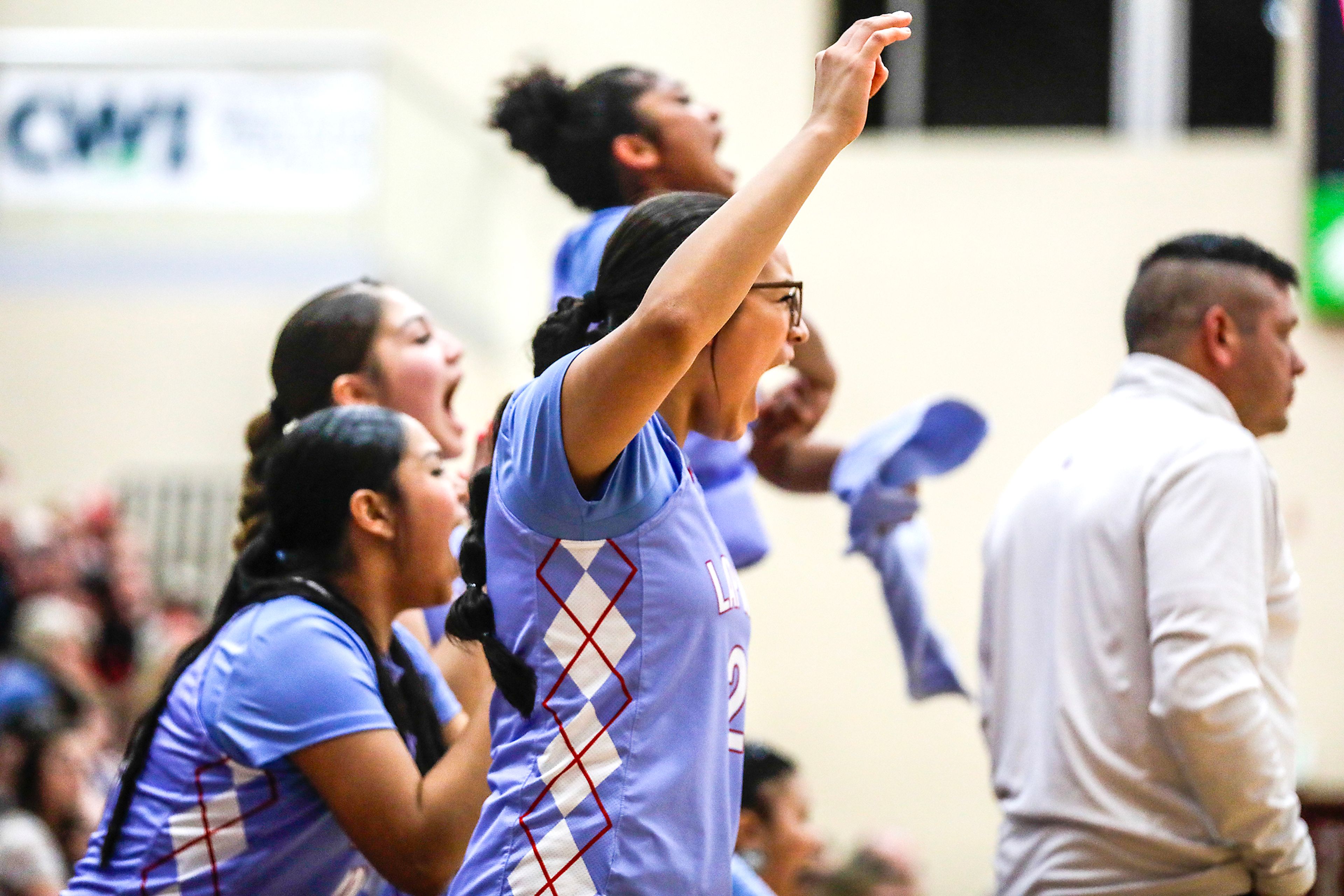 Lapwai's Junee Picard and others on the bench cheer on their team against Oakley during an Idaho Class 1A DI girls state semifinal game Friday at Columbia High School.