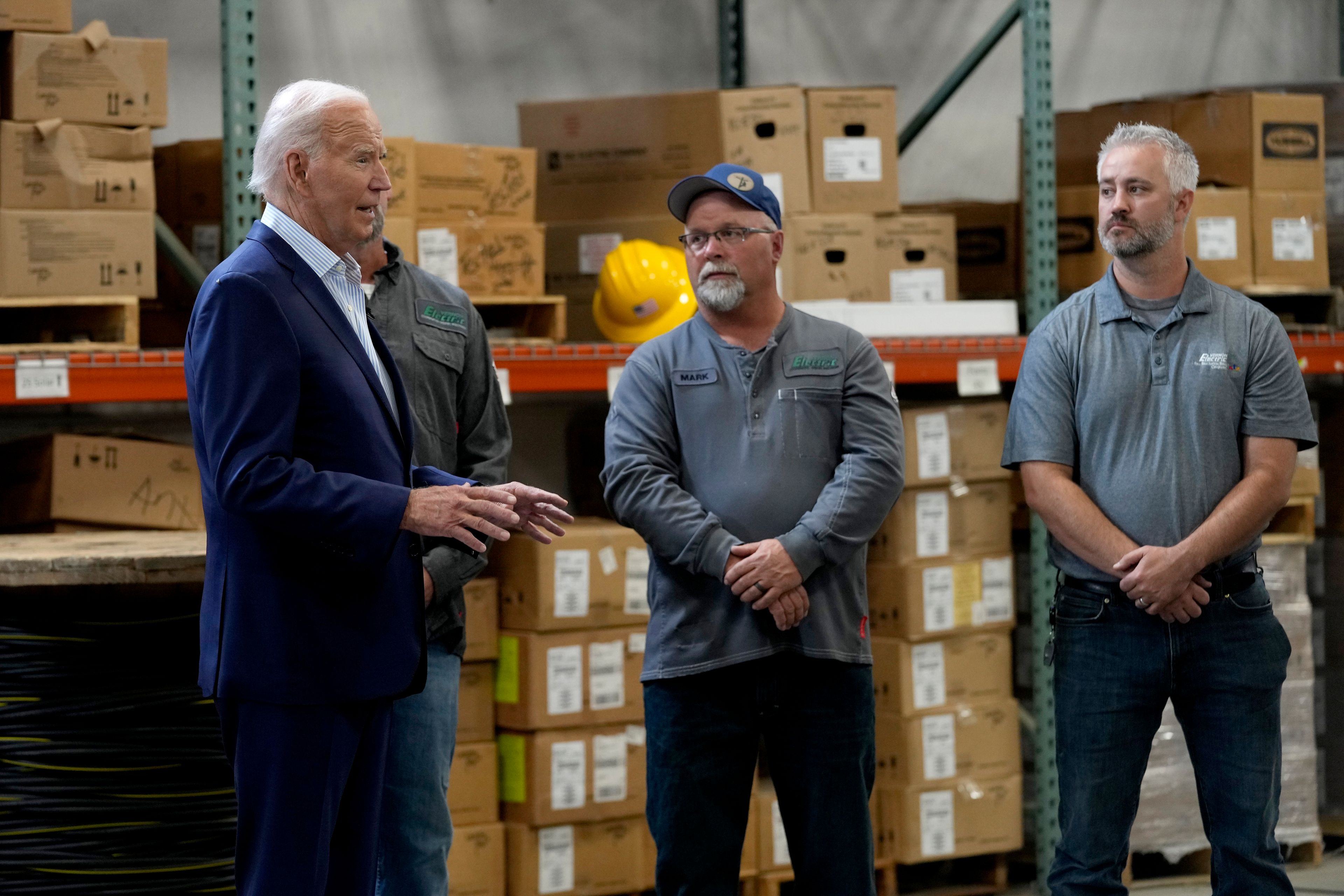 President Joe Biden, left, meets with workers from Dairyland Power Cooperative and Vernon Electric Cooperative during a visit to Vernon Electric in Westby, Wis., Thursday, Sept. 5, 2024. Biden is in Wisconsin to promote his Investing in America agenda.