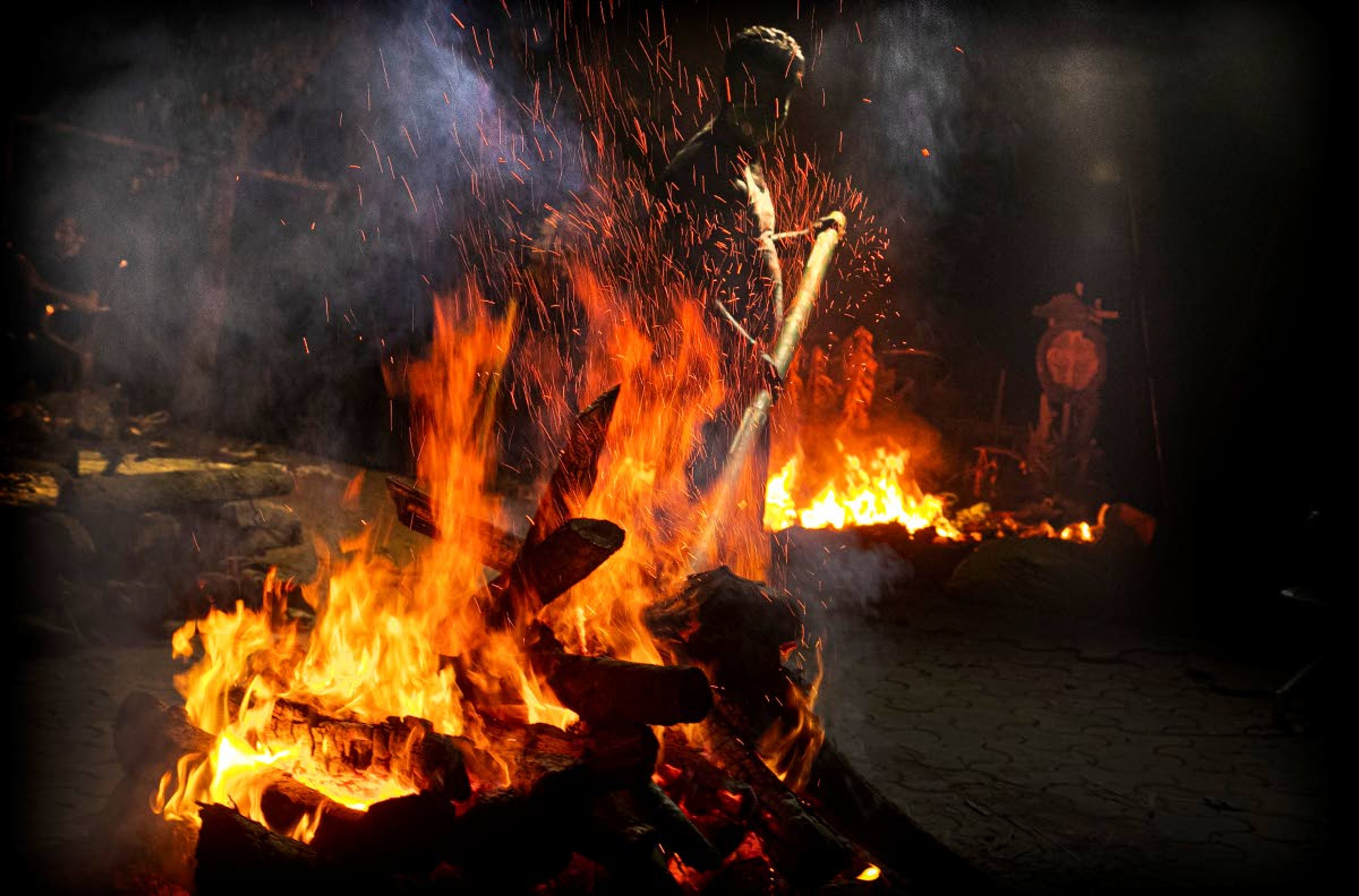 Ramananda Sarkar, 43, cremates the body of a COVID-19 victim in Gauhati, India, Monday, Sept. 14, 2020. While Hindu's believe cremation rights are sacred and release the dead person's soul from the cycle of rebirth, those who actually deal with corpses are looked down upon. It's a stigma that's only been made worse by the coronavirus, which has killed more than 100,000 people in India out of 6.4 million reported infections. Sarkar said he alone has cremated more than 450 COVID-19 victims. (AP Photo/Anupam Nath)