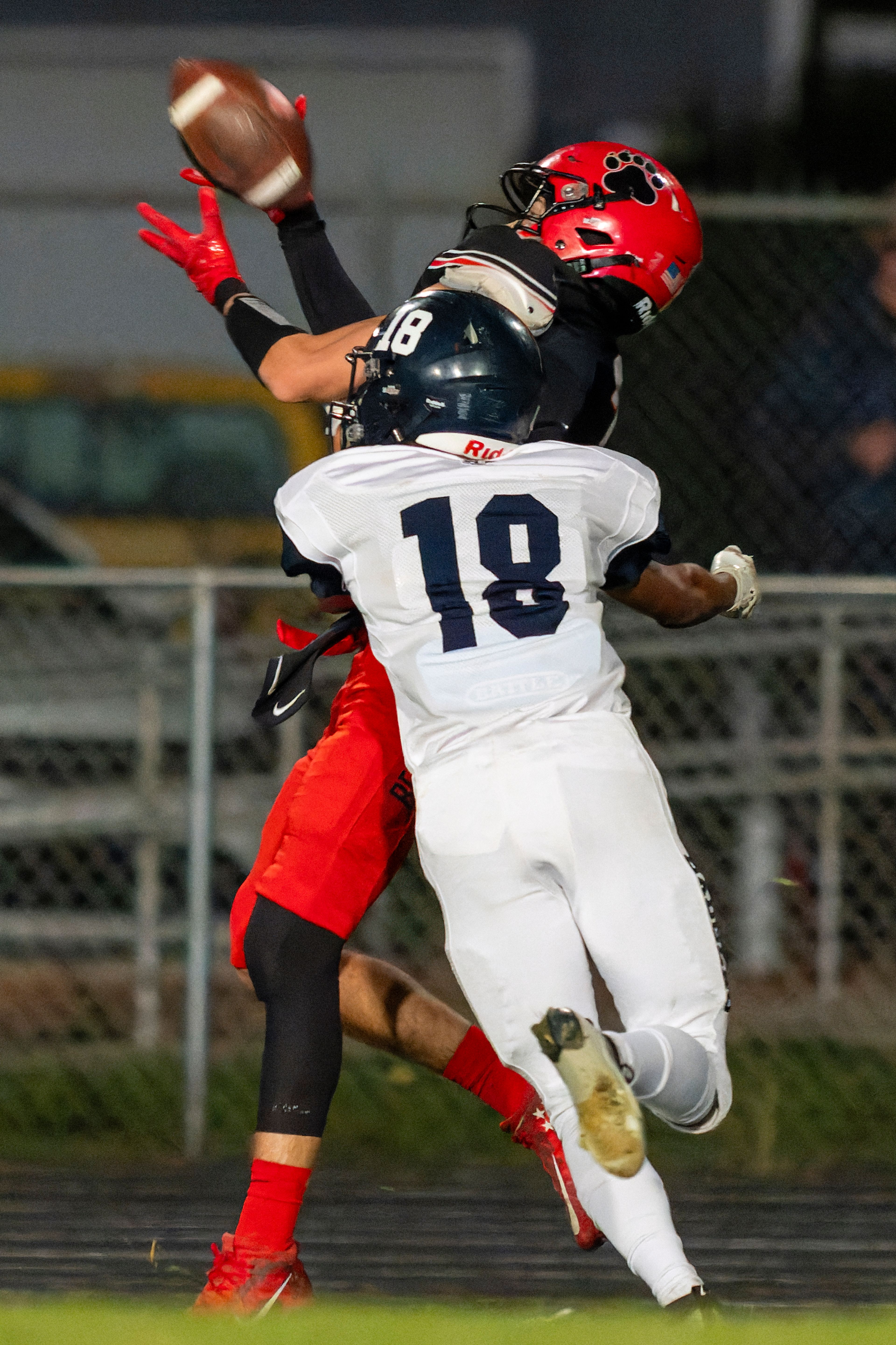 Moscow wide receiver Butch Kiblen (2) bobbles a pass under pressure from Bonners Ferry defensive back Gio Farsomi (18) during a game against the Bonners Ferry Badgers on Friday night at Bear Field in Moscow.