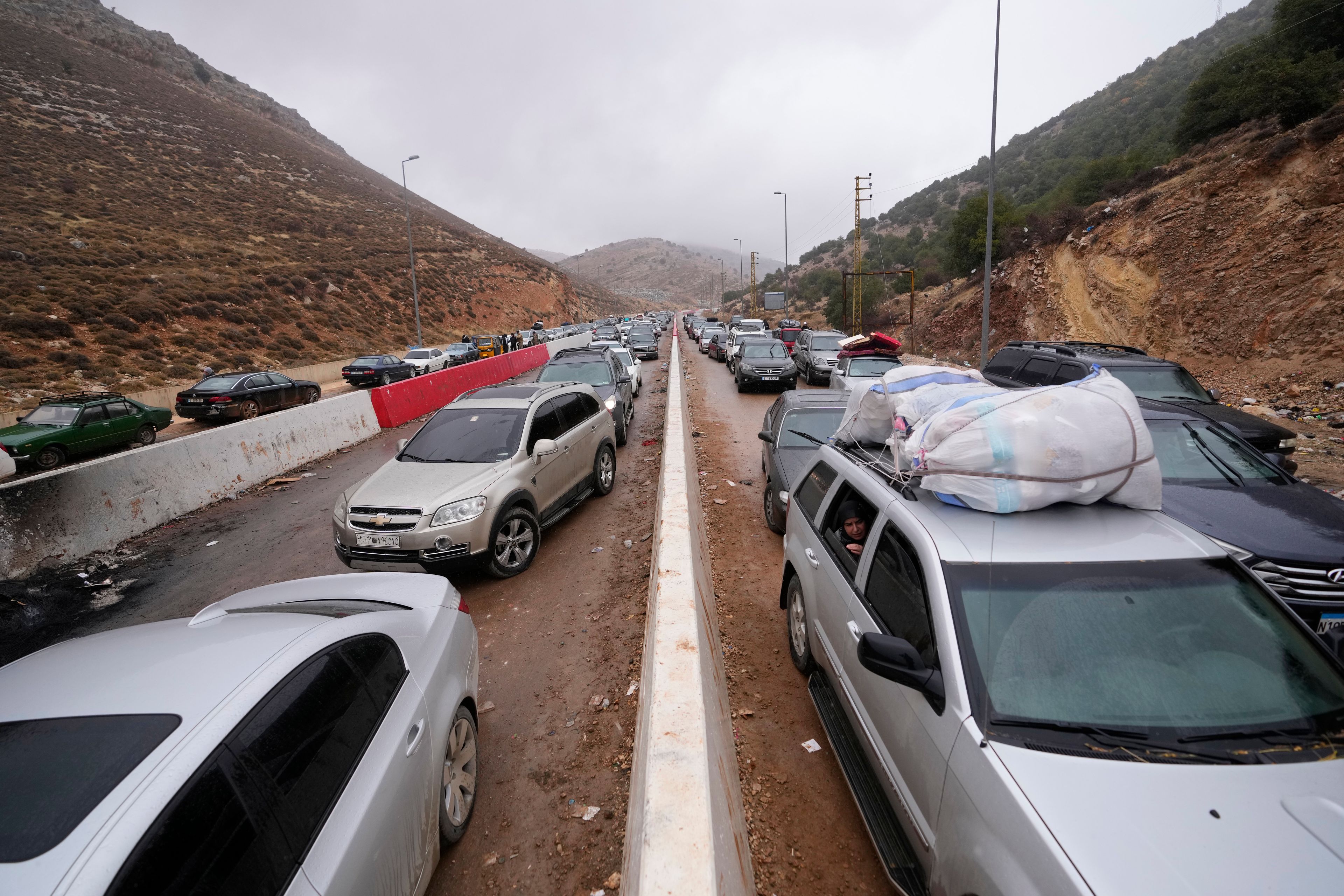 Displaced residents return from Syria at the Masnaa border crossing, eastern Lebanon, following a ceasefire between Israel and Hezbollah on Wednesday, Nov. 27, 2024. (AP Photo/Hassan Ammar)