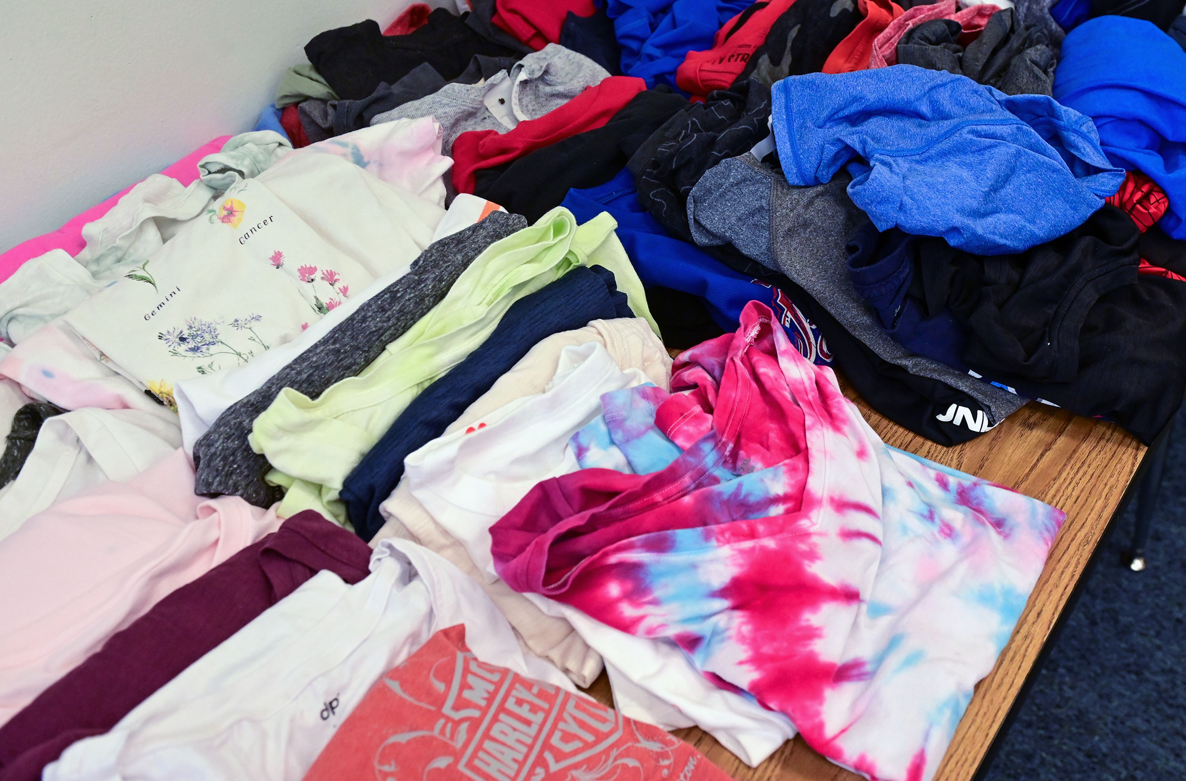 Shirts are laid in neat rows ready to be selected by students at the Moscow School District Family Resource Hub in the Russell Elementary building Thursday in Moscow.