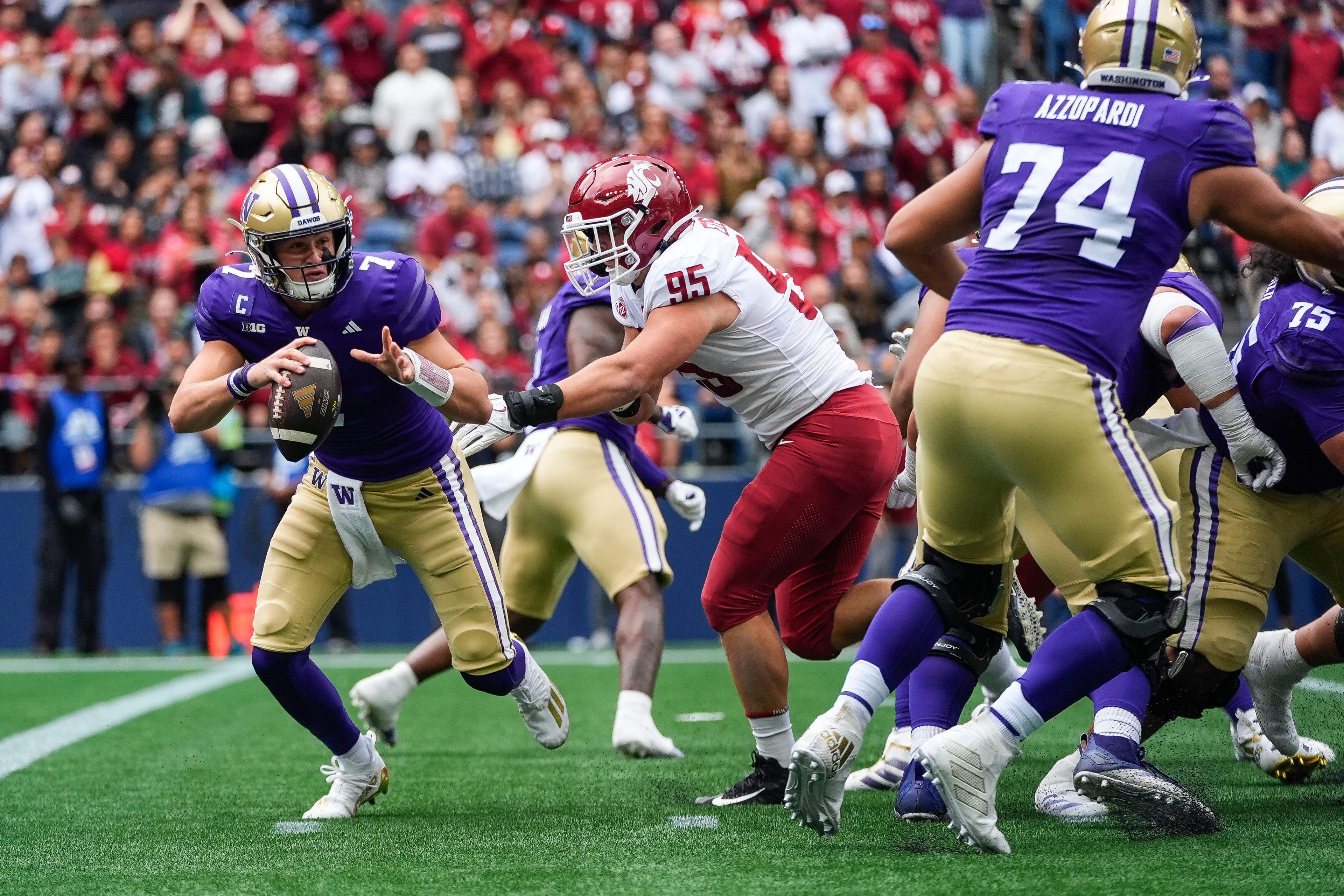 Washington quarterback Will Rogers (7) is pressured by Washington State edge Andrew Edson (95) during the first half of an NCAA college football game Saturday, Sept. 14, 2024, in Seattle. (AP Photo/Lindsey Wasson)