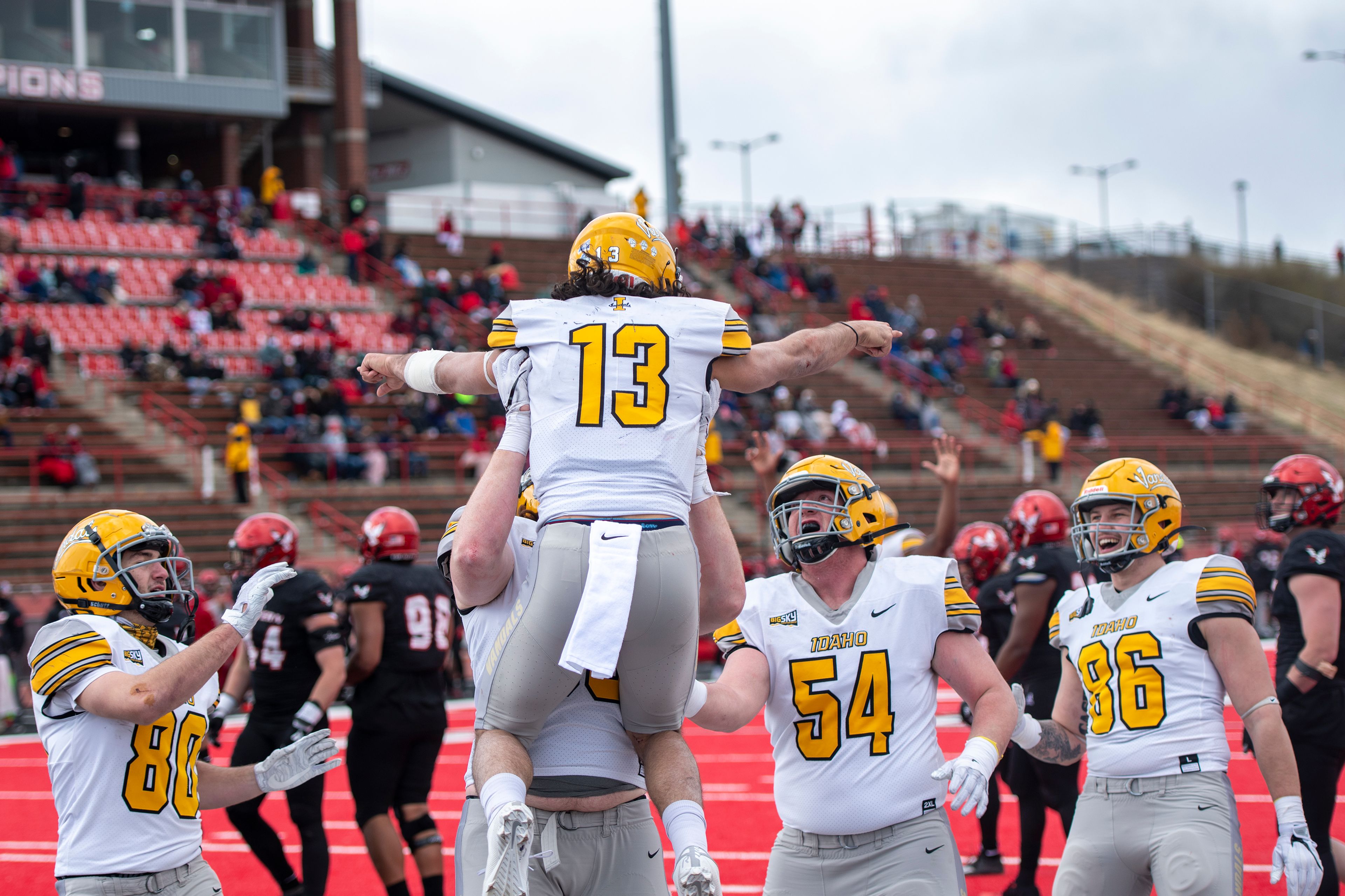 Idaho quarterback Zach Borisch (13) is lifted up by offensive lineman Seth Carnahan (68) after scoring a touchdown during the third quarter of a Big Sky Conference matchup at Roos Field on Saturday afternoon. Eastern Washington defeated Idaho 38-31.