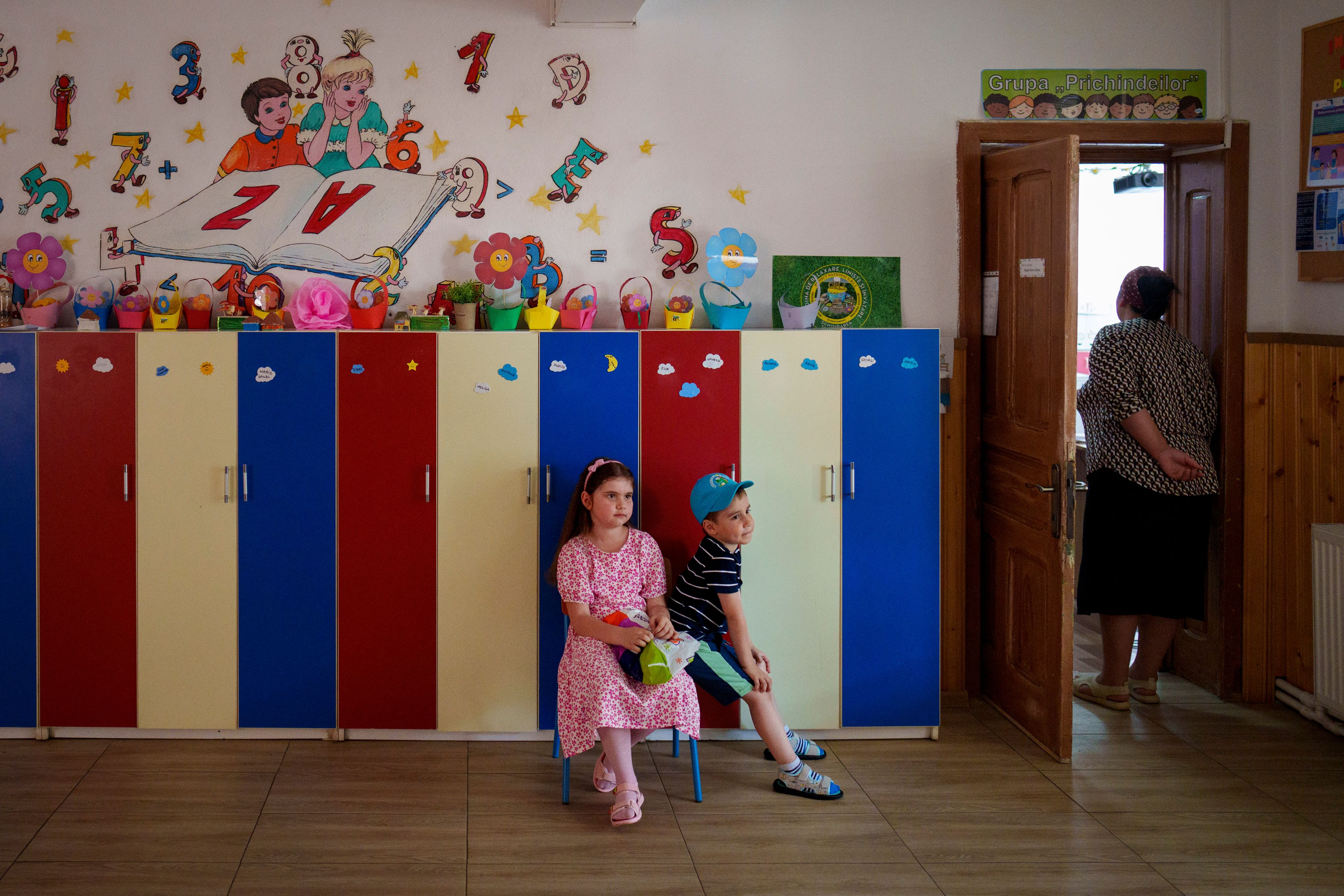 Children wait for their relatives to vote in European Parliament and local elections in Baleni, Romania, Sunday, June 9, 2024. Voters across the European Union are going to the polls on the final day of voting for the European parliamentary elections to choose their representatives for the next five-year term.