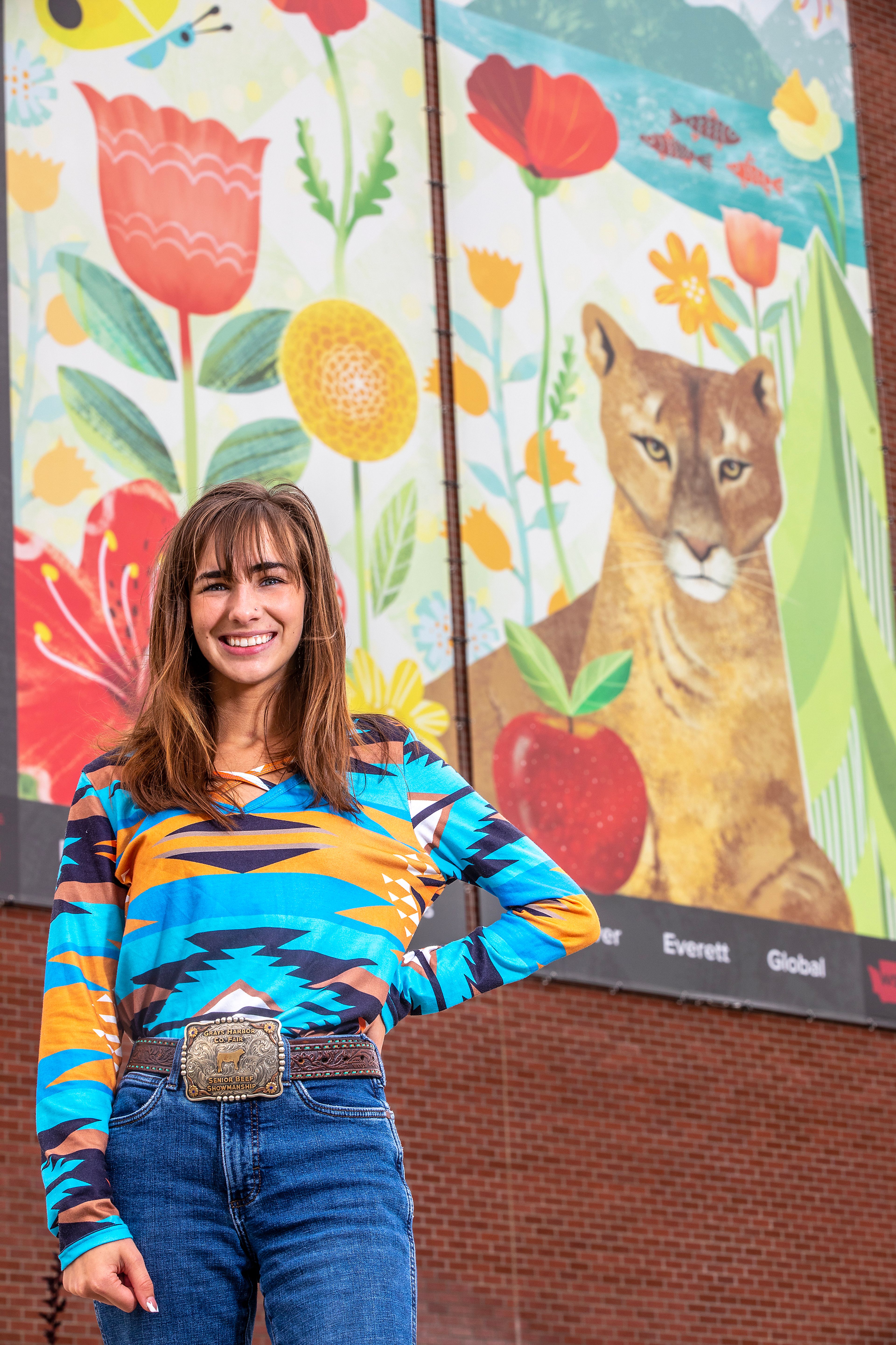 Emma Spalding poses for a photo in front of a cougar picture on the Washington State University campus Monday in Pullman.