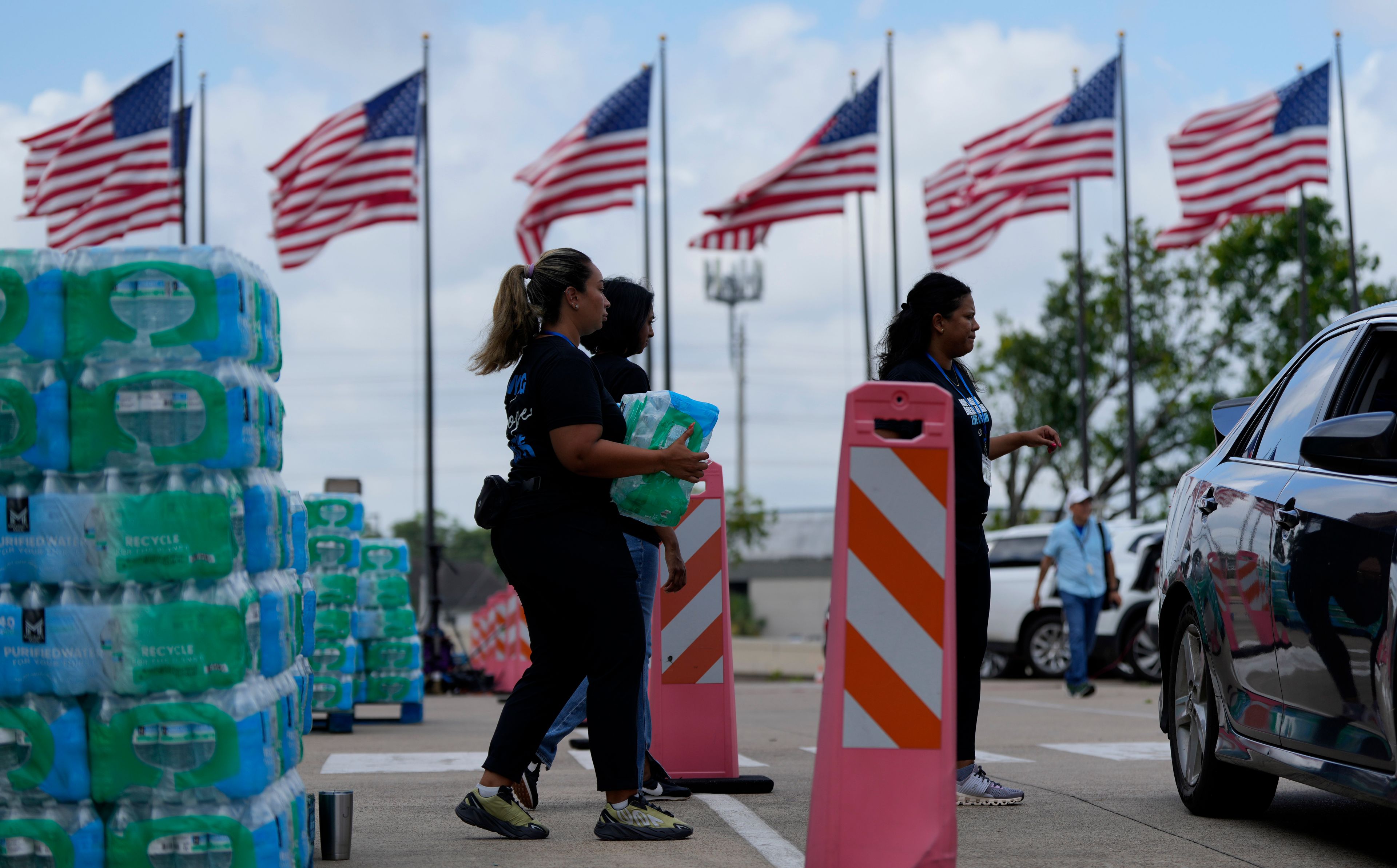 Staff at Lakewood Church hand out water and operate a cooling station in Houston, Tuesday, July 9, 2024. The effects of Hurricane Beryl left most in the area without power. (AP Photo/Eric Gay)