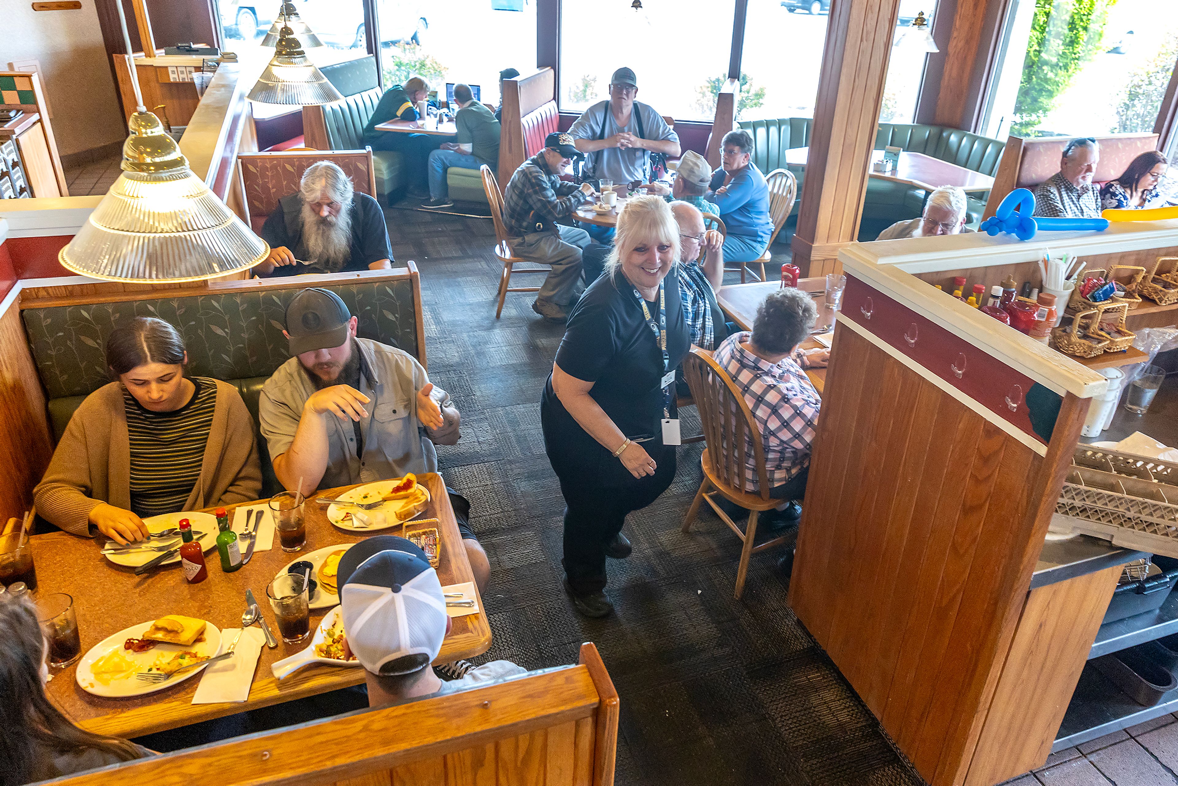 Sharis Restaurant sits packed with people on its last day of service Monday in Lewisotn.