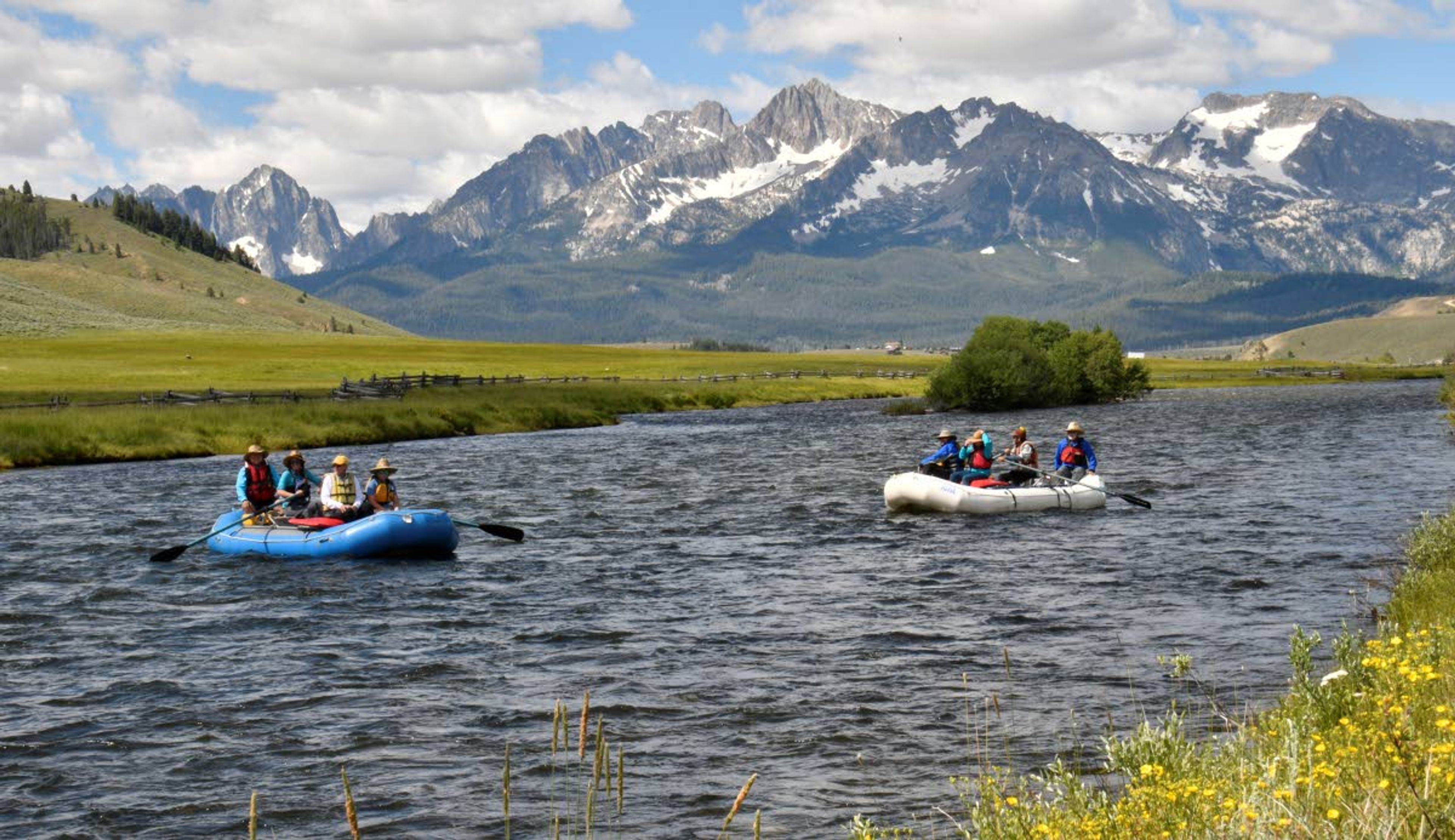 ABOVE: Members of the Source-to-Sea trip float the upper Salmon River with the Sawtooth Mountains in the background.left: Doug Lawrence cooks up a feast in Dutch ovens during a raft trip from the source of the Salmon River to the sea.Photos courtesy Steve Stuebner