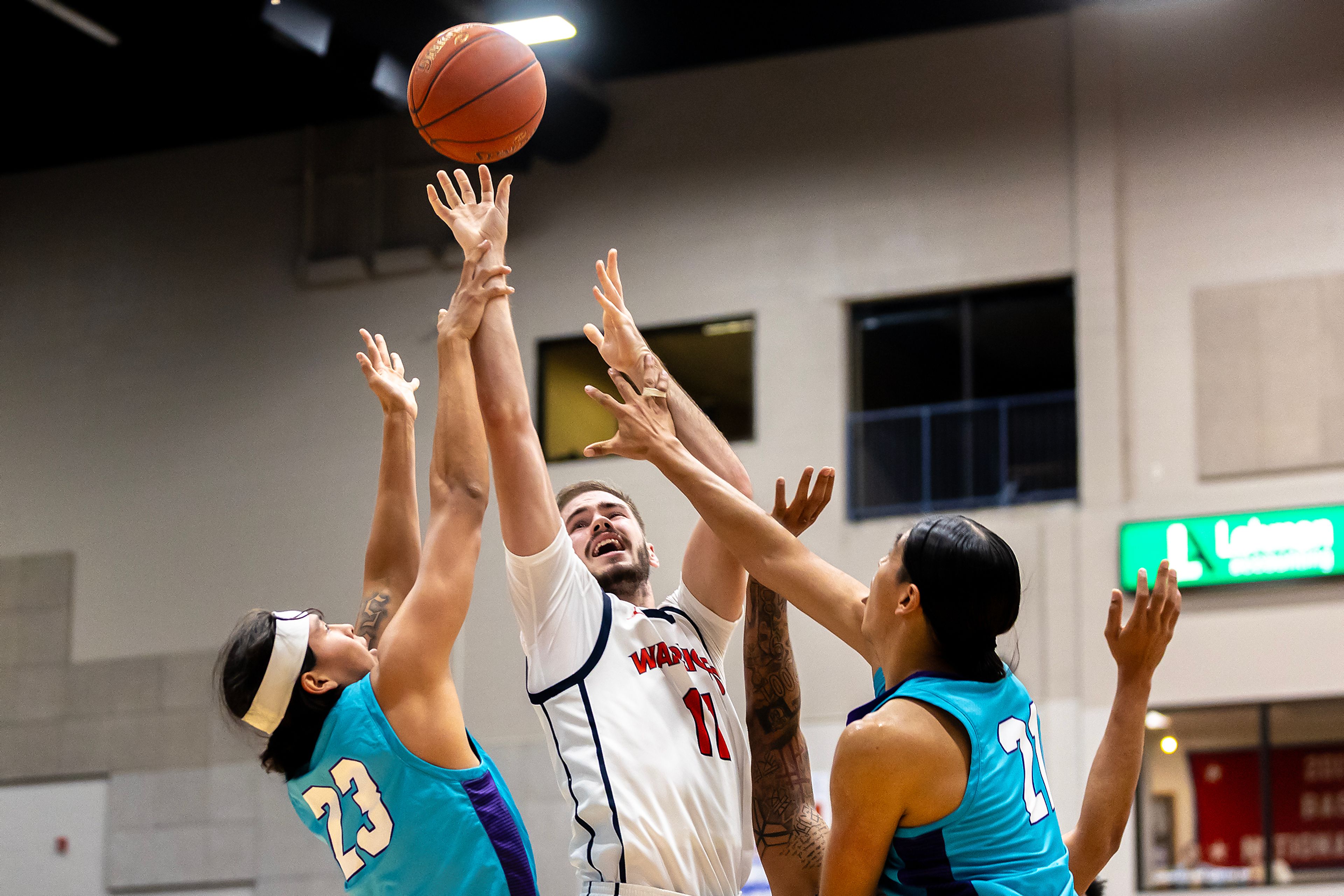 Lewis-Clark State forward Grayson Hunt shoots the ball under pressure from Haskell�s Khohanon Atazhoon (23) and Alexander Ellenwood during the season opening game as part of Tribal Nations Weekend Saturday in Lewiston.,