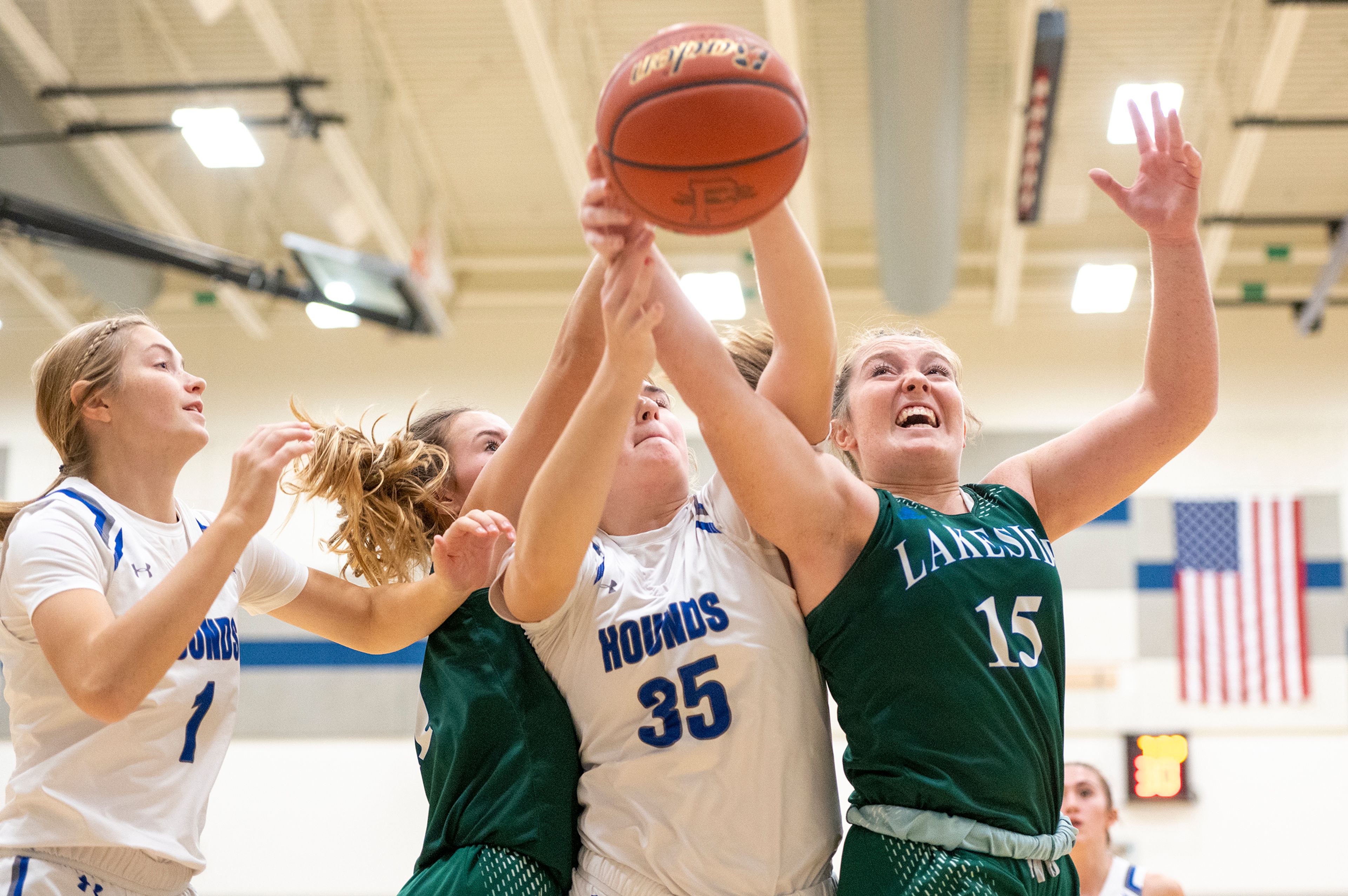 Pullman post Ryli Bednar, center, fights for a rebound with Lakeside guard Sophia Stadler, right, during Friday's nonleague game.