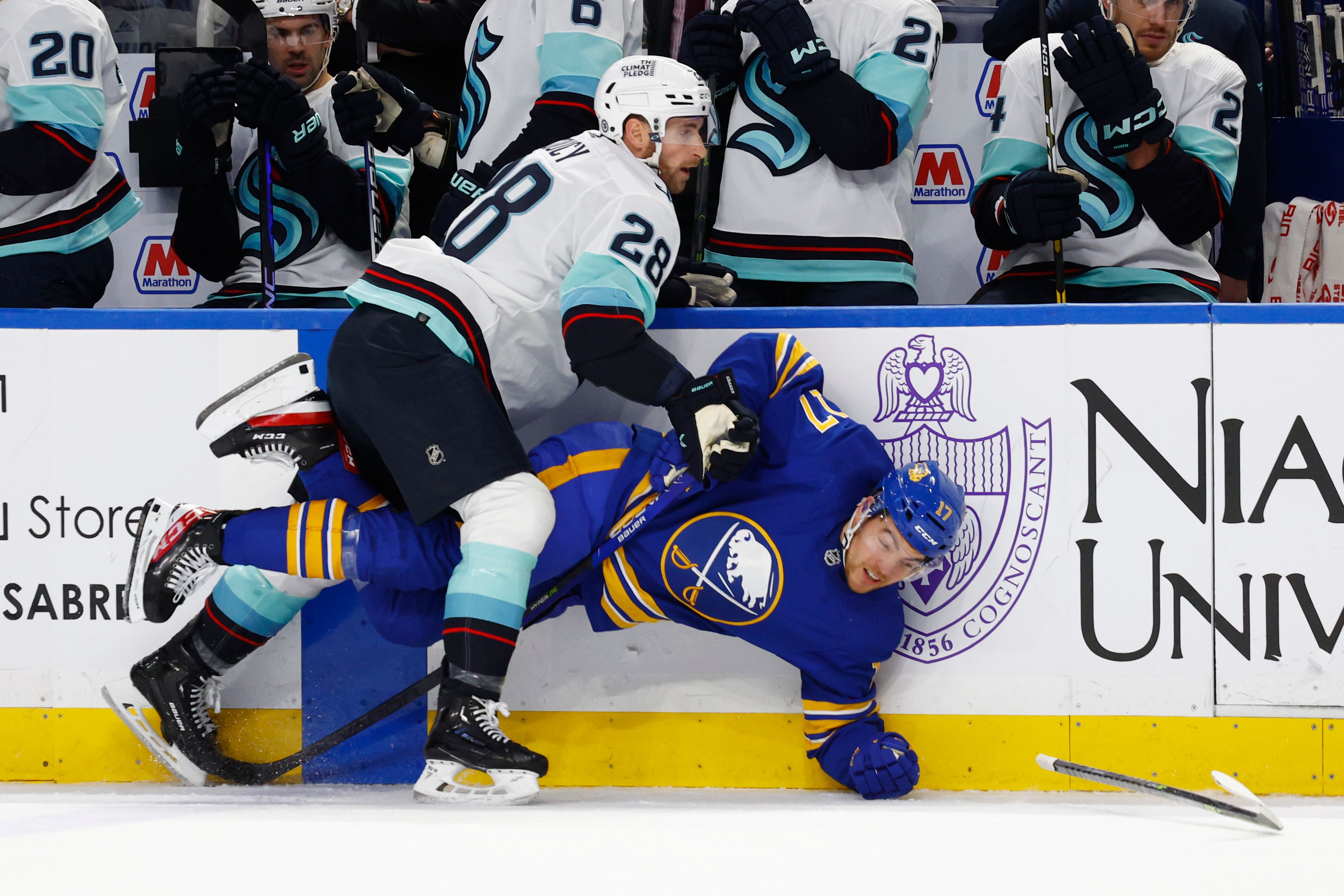 Buffalo Sabres center Tyson Jost (17) is checked by Seattle Kraken defenseman Carson Soucy (28) during the first period of an NHL hockey game, Tuesday, Jan. 10, 2023, in Buffalo, N.Y. (AP Photo/Jeffrey T. Barnes)